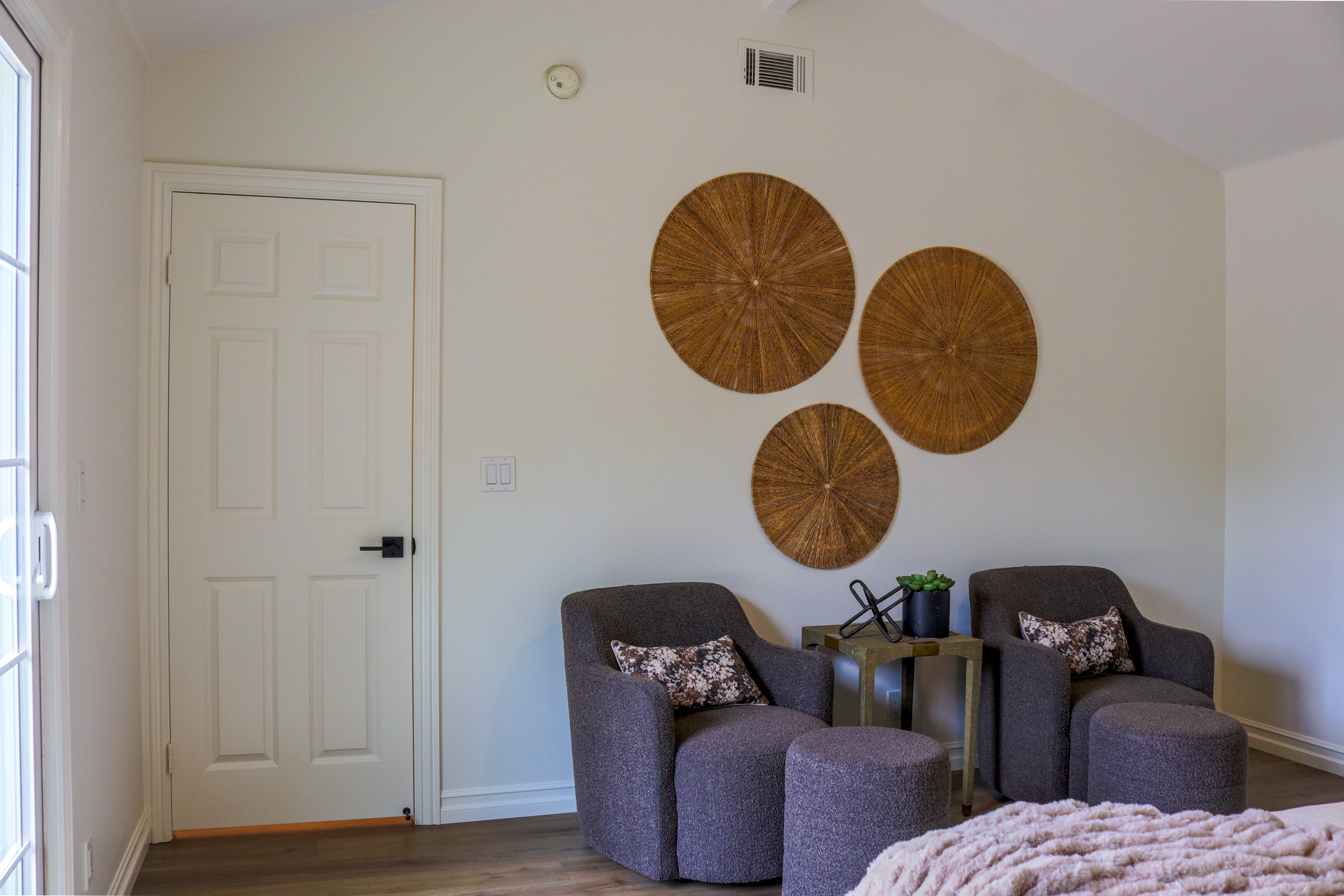 Sitting area with paired armchairs and woven wall art, Tustin home for sale