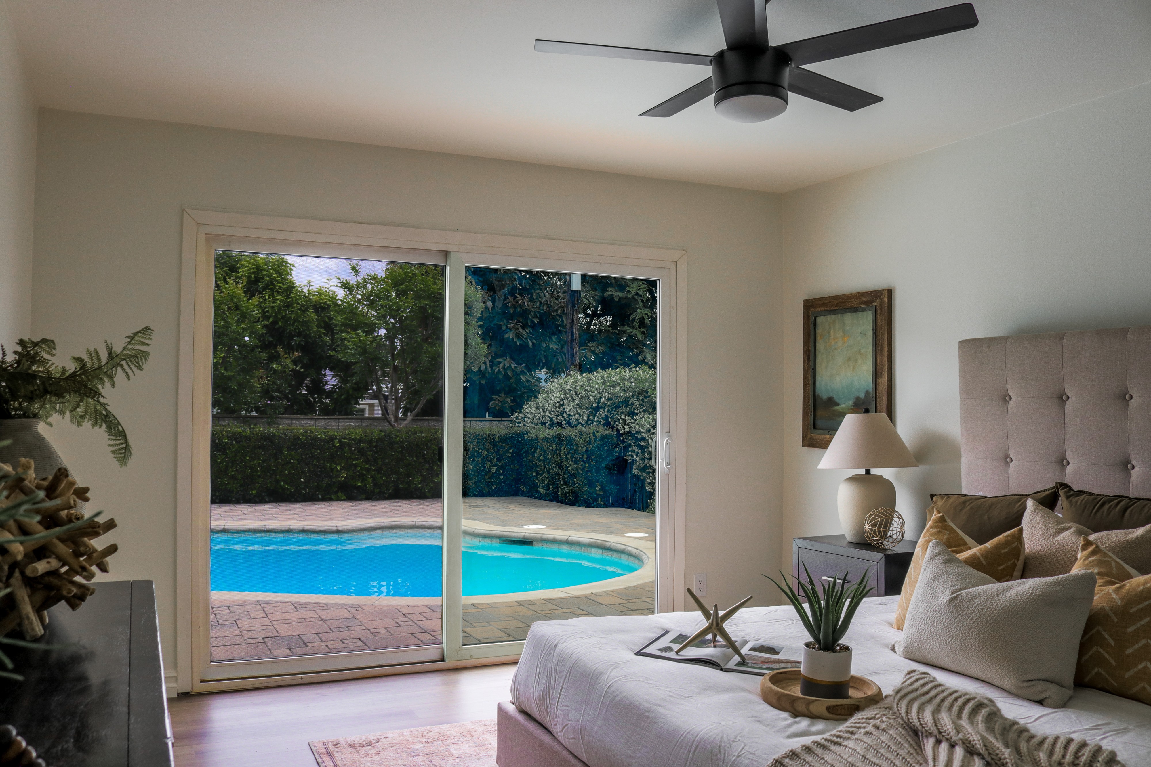 Bedroom with ceiling fan and sliding door overlooking the pool, Tustin home for sale