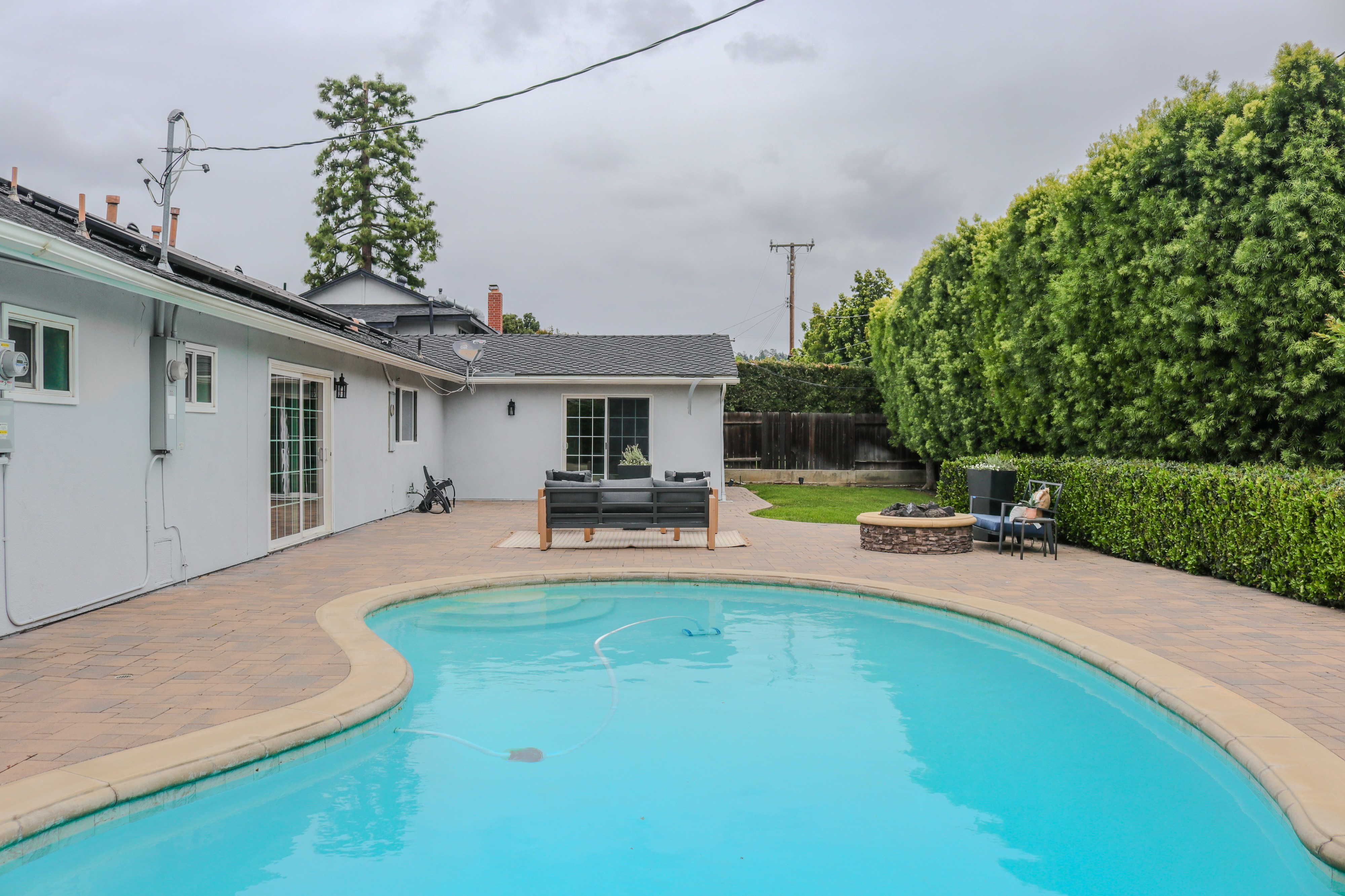 Pool and rear elevation of the house at dusk light, Tustin residential listing