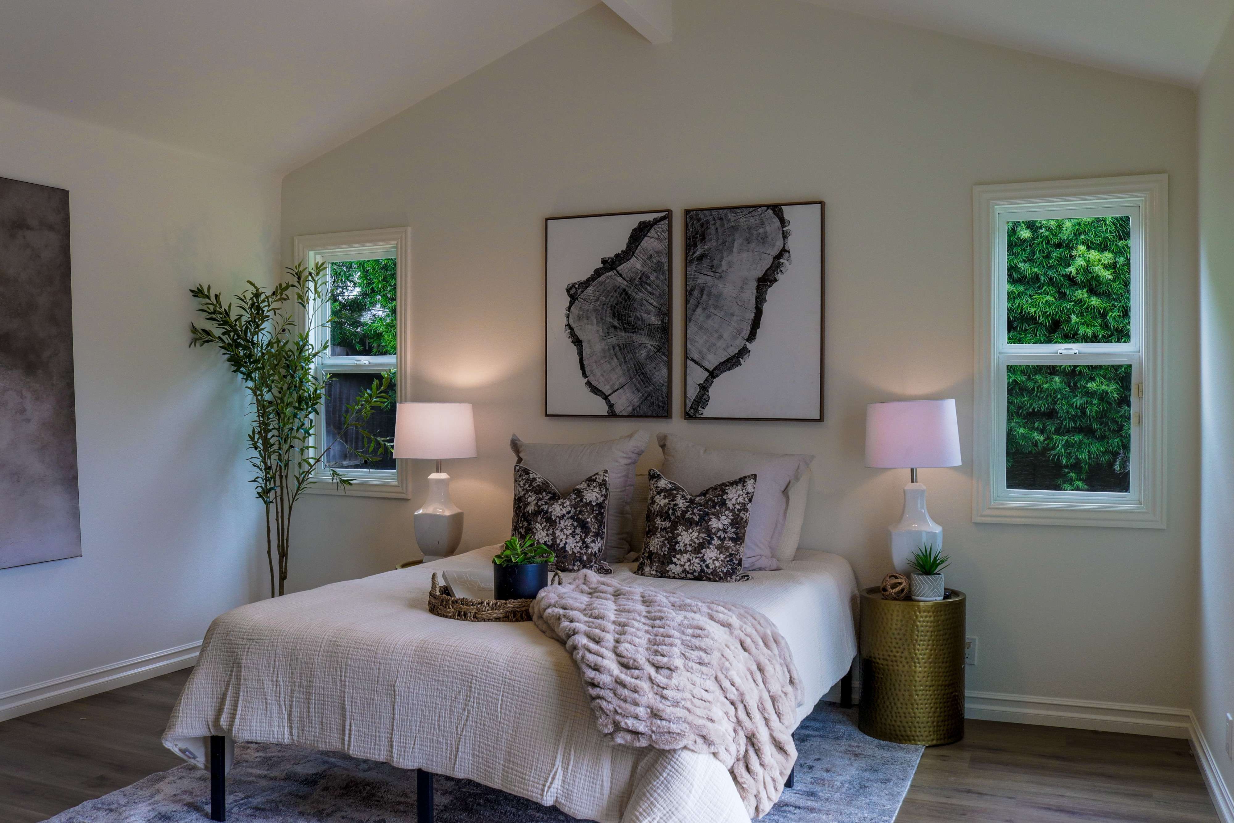 Staged primary bedroom with layered bedding and bedside lamps, Tustin residential listing