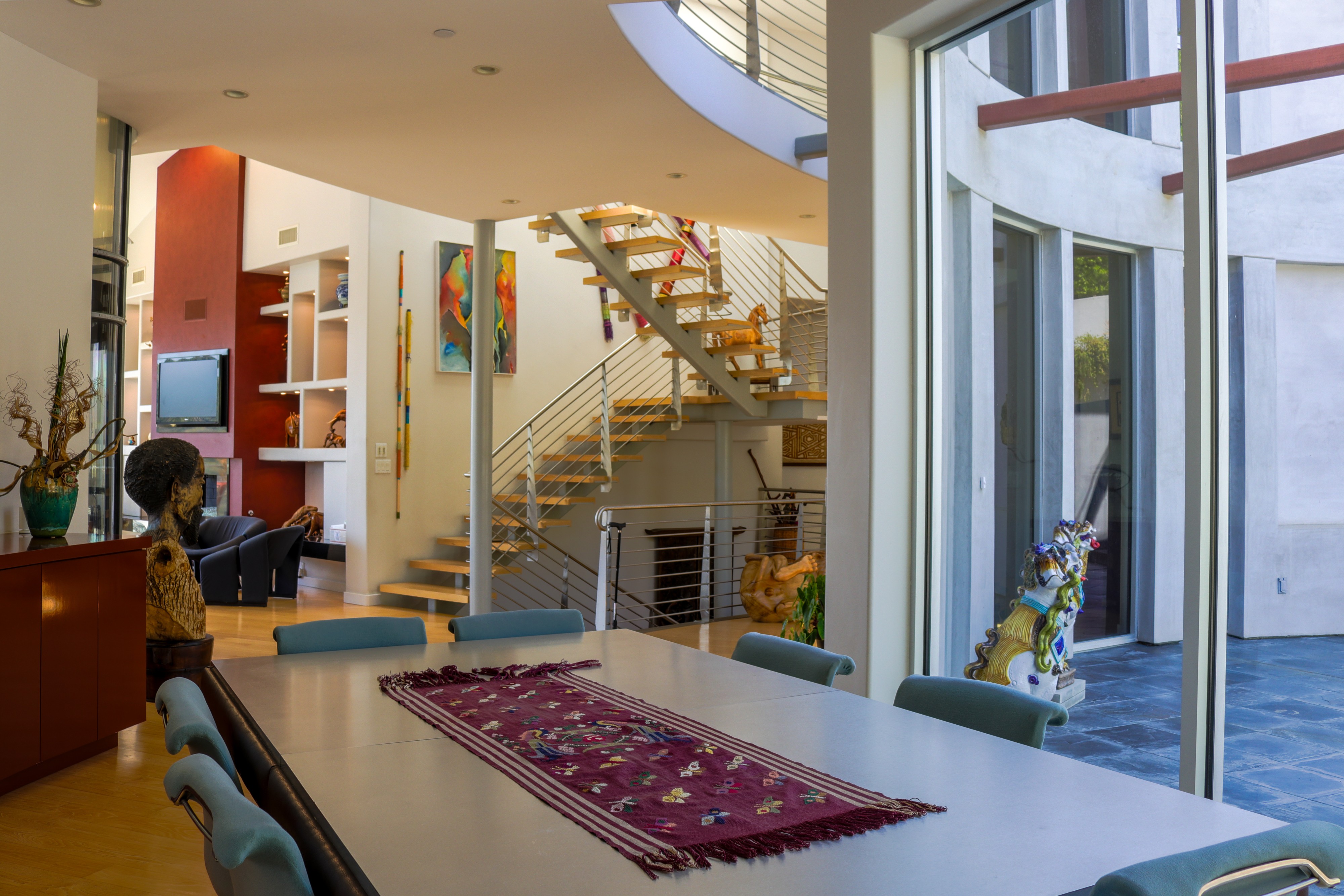Dining area beside the open staircase and glass doors, Tustin luxury listing
