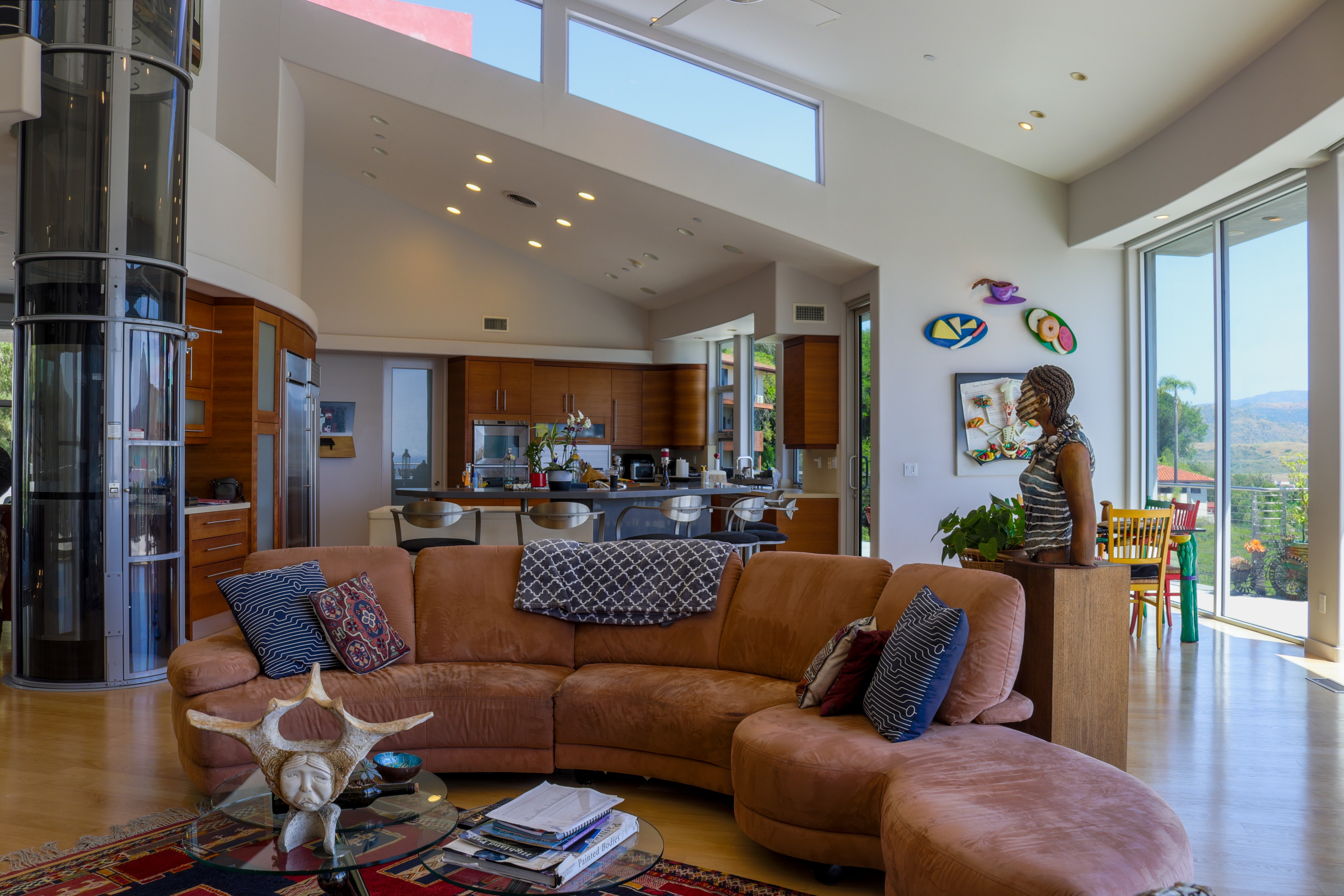 Open-plan living room with leather seating and sliding doors to the patio, Orange County listing