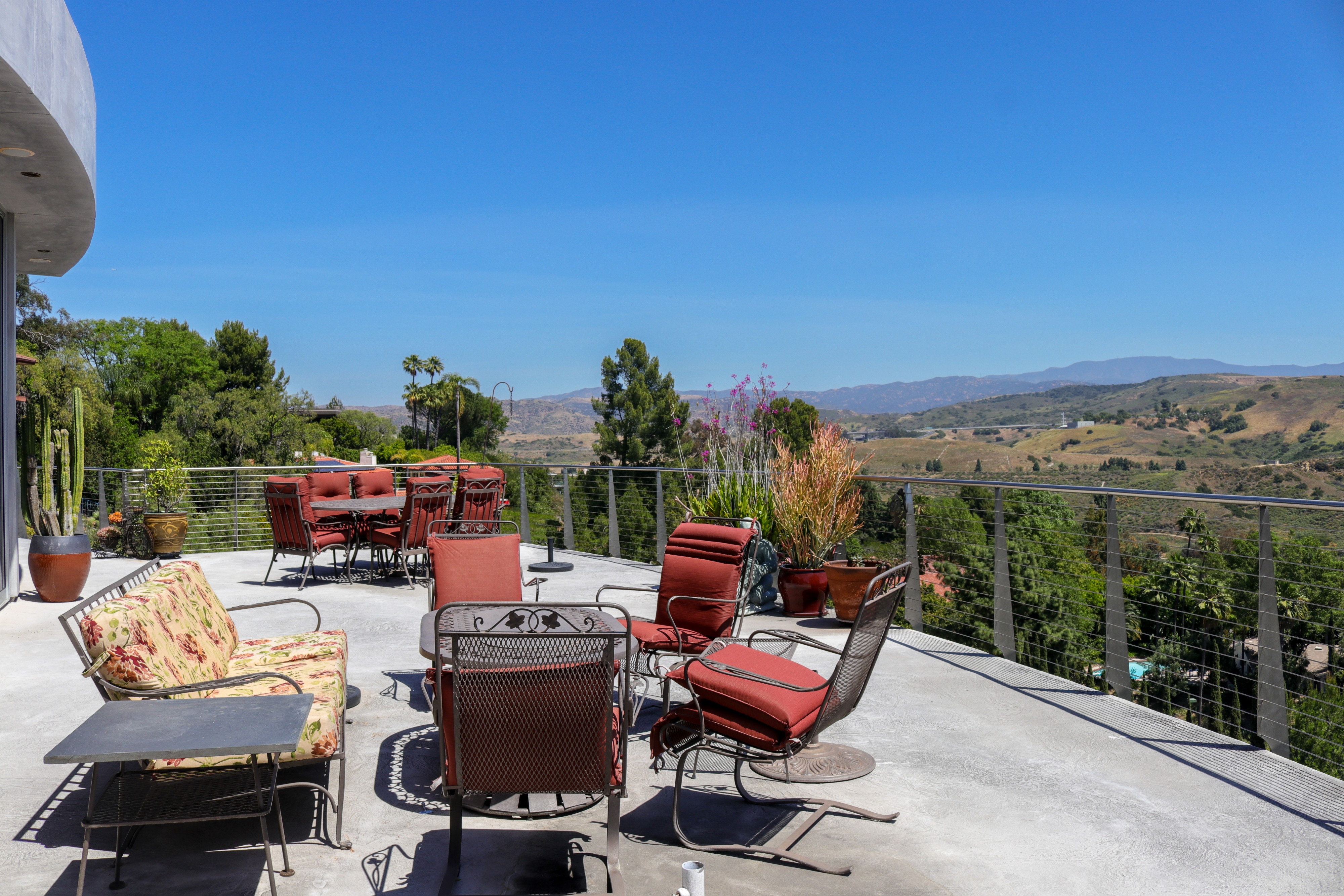 Terrace lounge seating with cactus planting and open valley views, Tustin luxury home