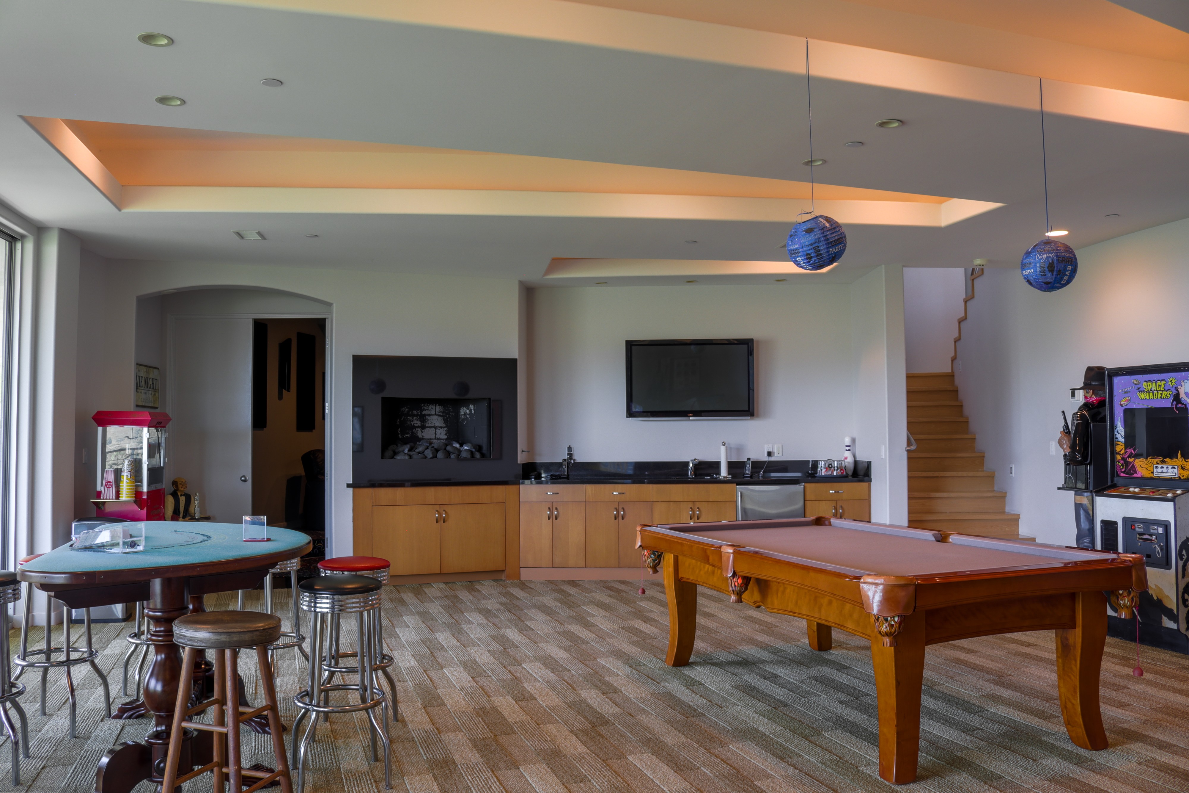 Games lounge with poker table, bar seating and billiards, Tustin luxury listing