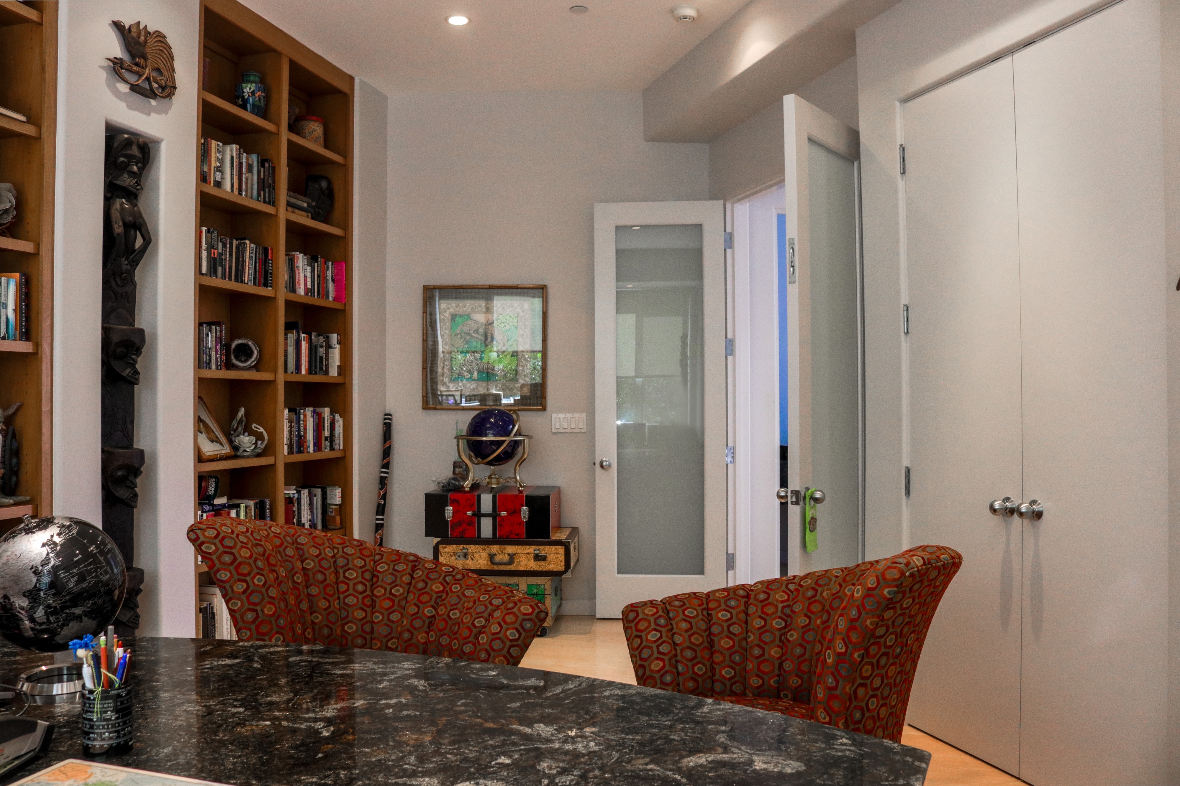 Library with built-in bookshelves and stone counter, Tustin luxury listing