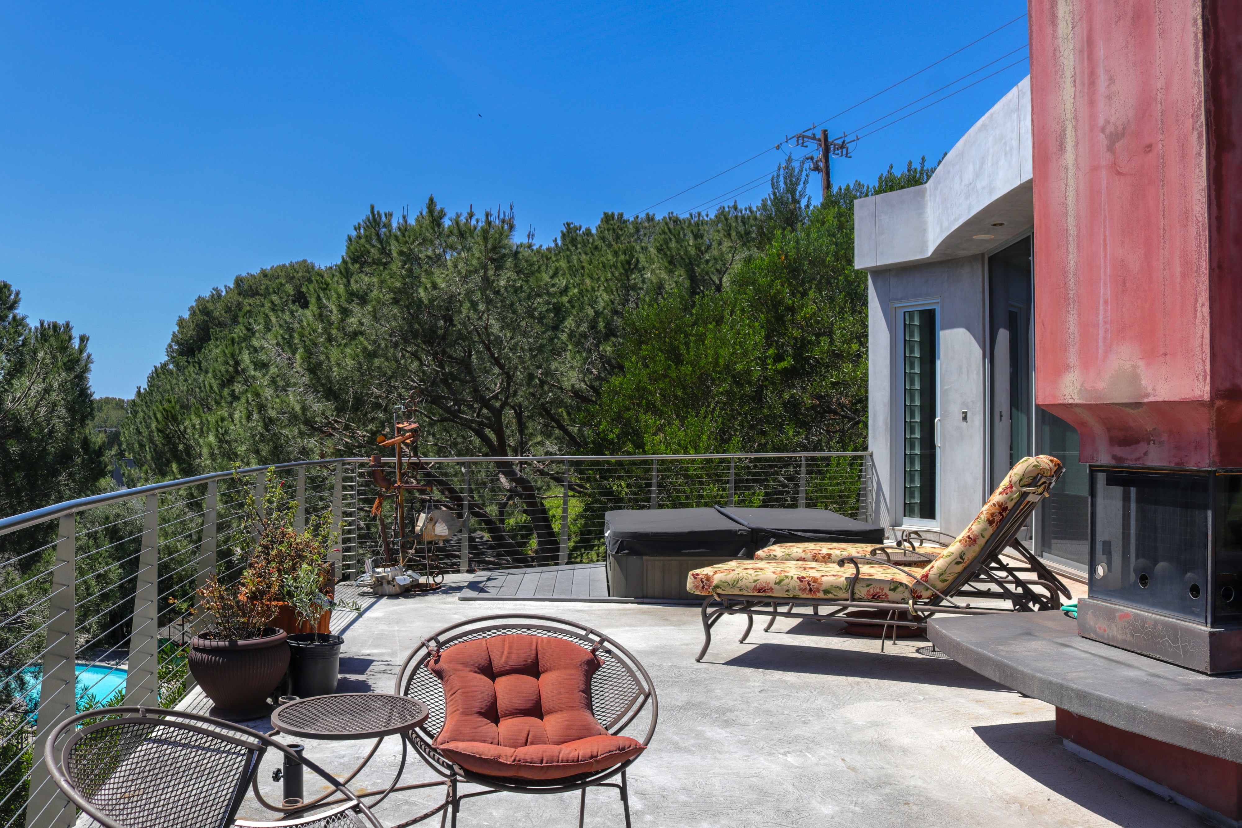 Sun deck with loungers and fire feature above the canyon, Tustin hillside listing