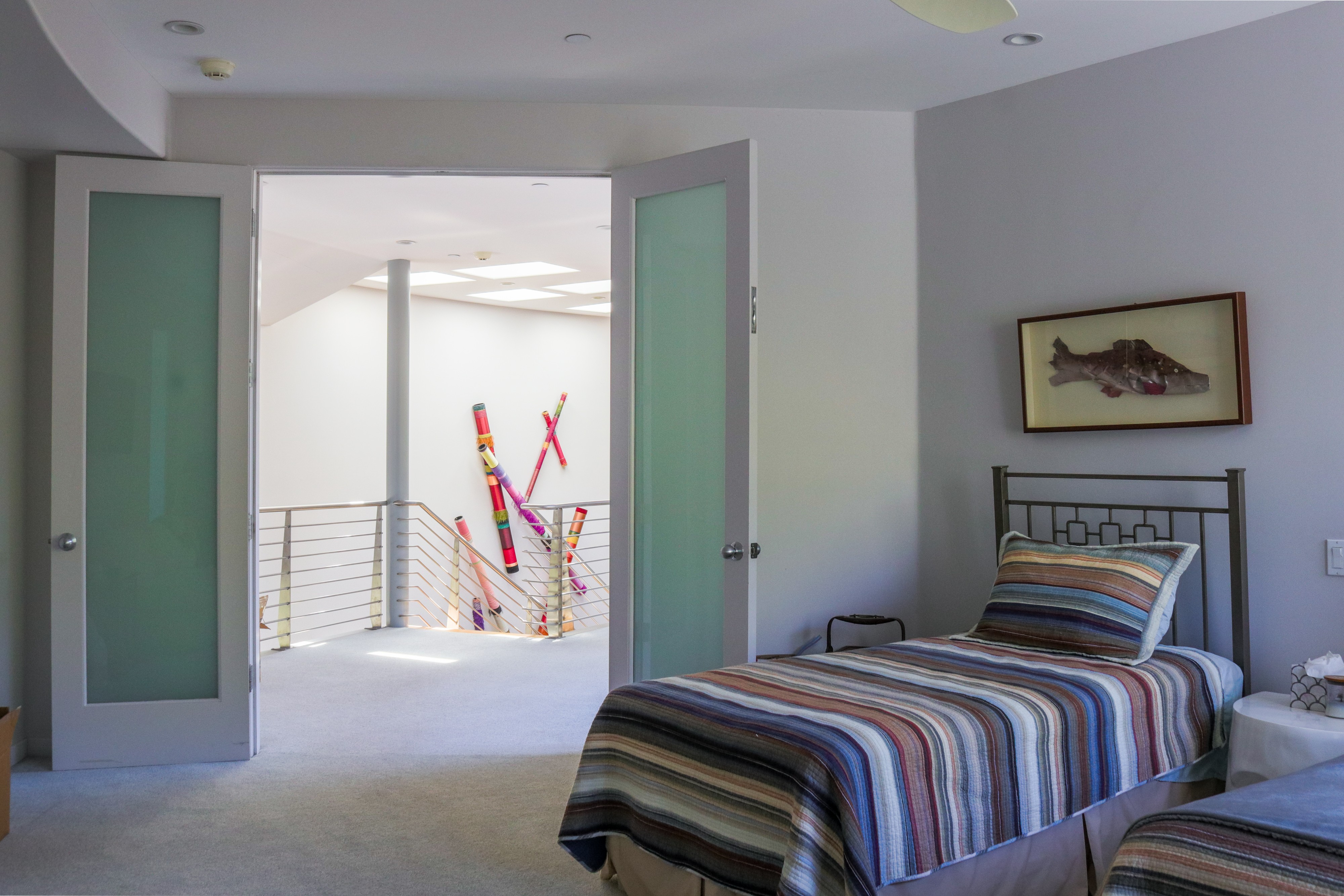 Hallway with glass doors and gallery artwork, Tustin luxury listing