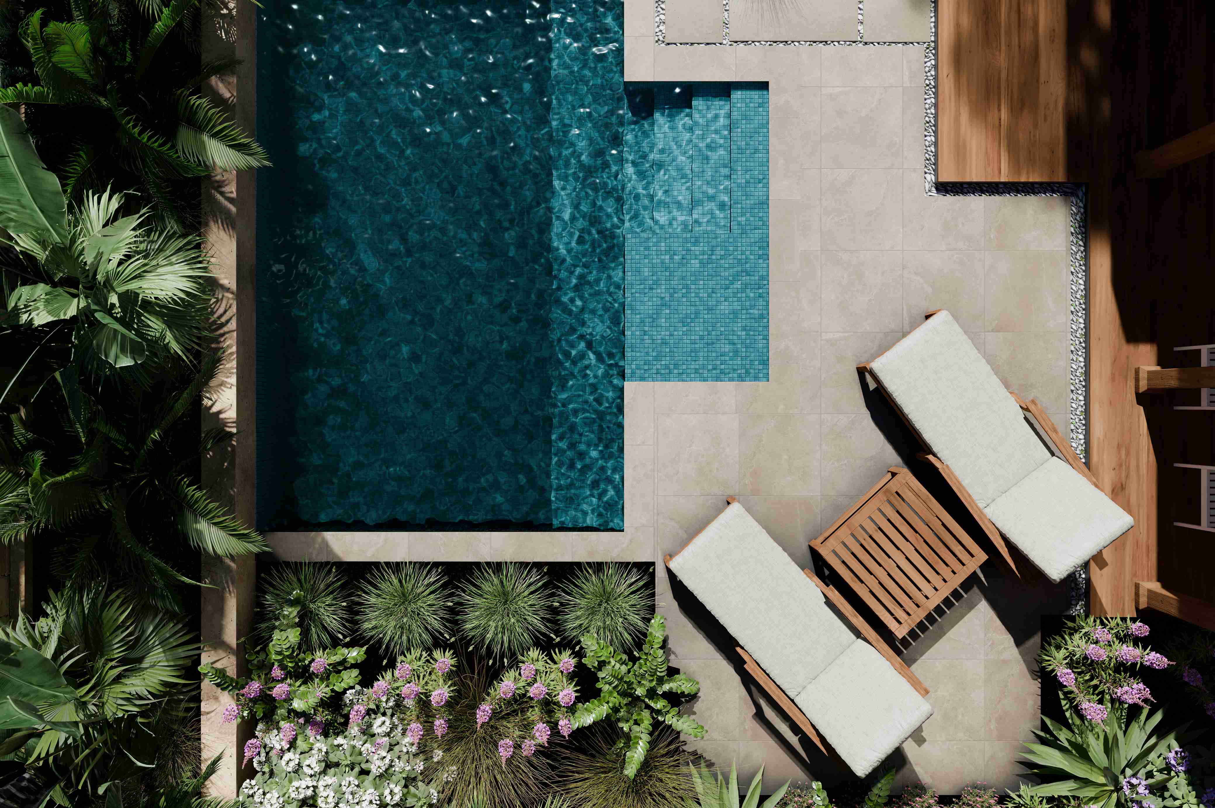 Overhead view of a hotel plunge pool with sun loungers and planting