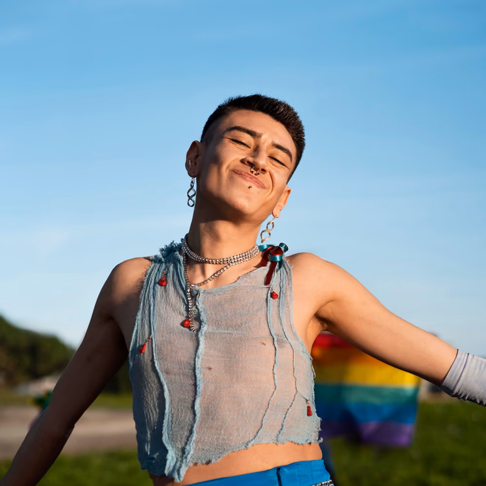 Confident non-binary person in a natural, warmly lit portrait