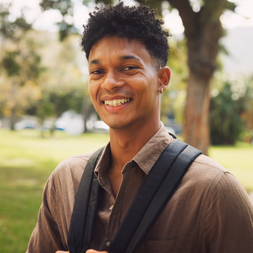 Smiling young man with short brown hair, warm and approachable portrait