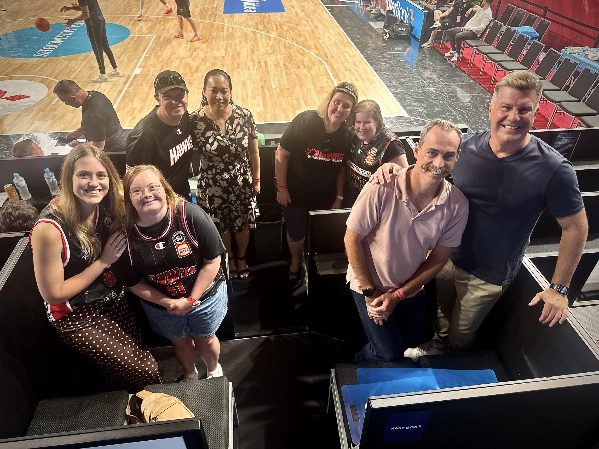 Illawarra Champions and Joint Vision team celebrating at the Illawarra Hawks game as part of the Moving Forward initiative.