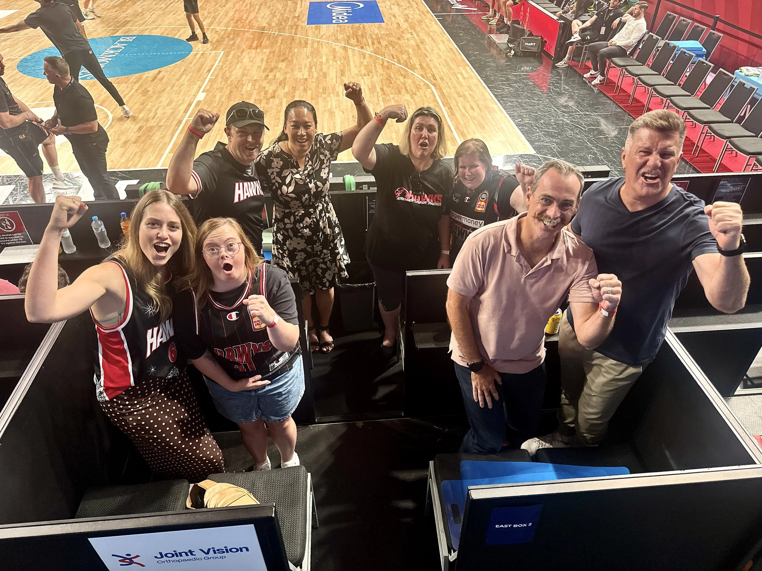 Illawarra Champions and Joint Vision team celebrating at the Illawarra Hawks game as part of the Moving Forward initiative