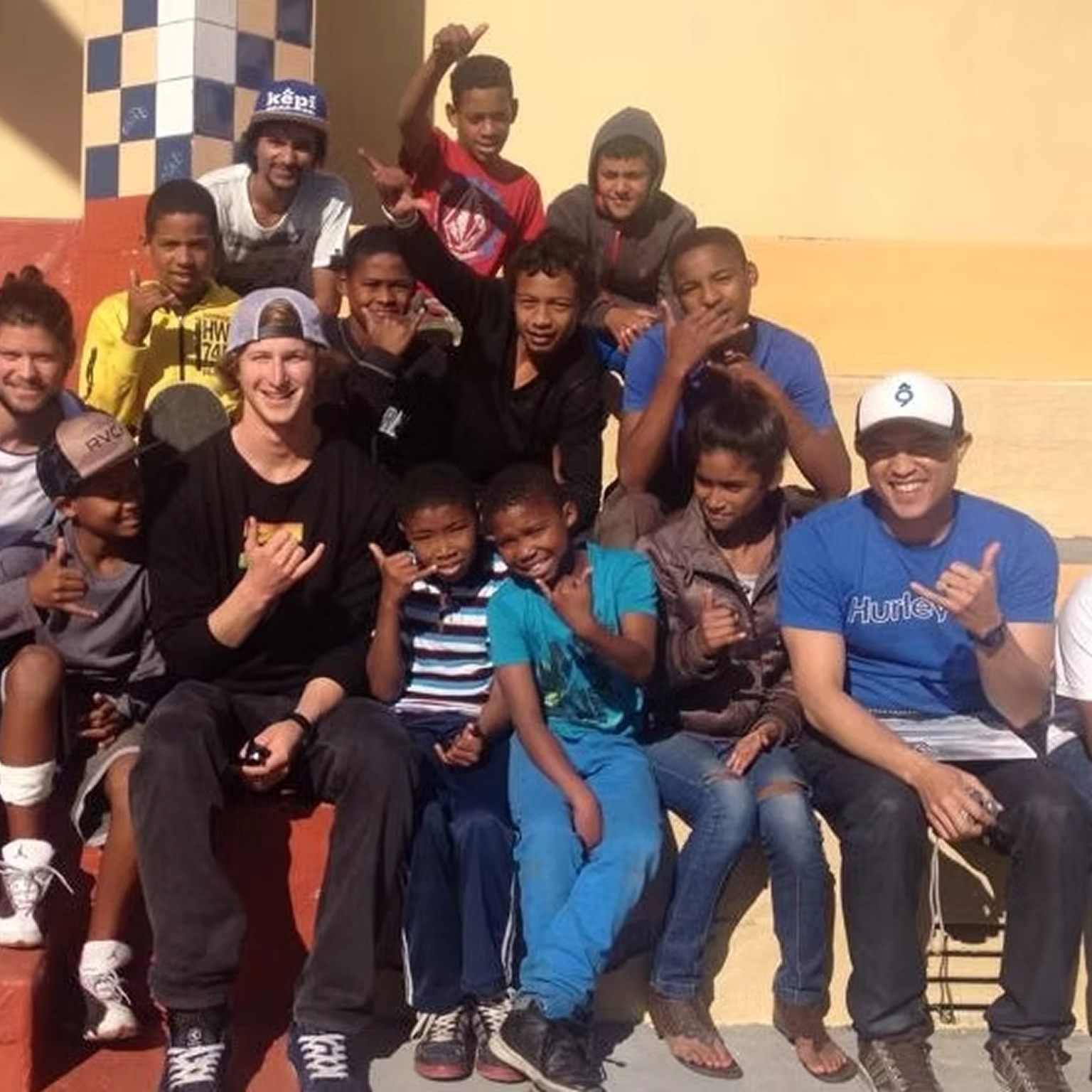 Matt Bromley posing with a large group of smiling children at a community event