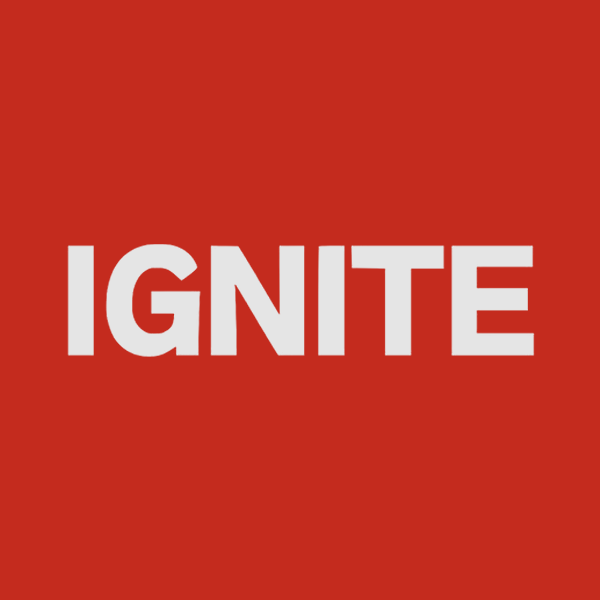 The word IGNITE in bold white uppercase letters centered on a solid red background.