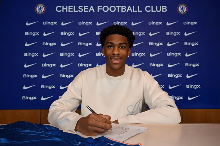 A young player signing his contract at Chelsea Football Club