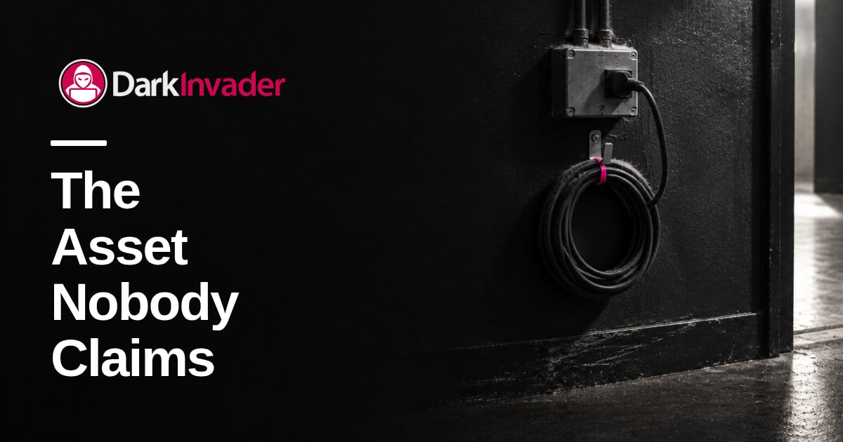 A black cable plugged into a grey wall box, coiled on a hook with a pink tie, dusty in a dim corridor, with the words "The Asset Nobody Claims" set on it
