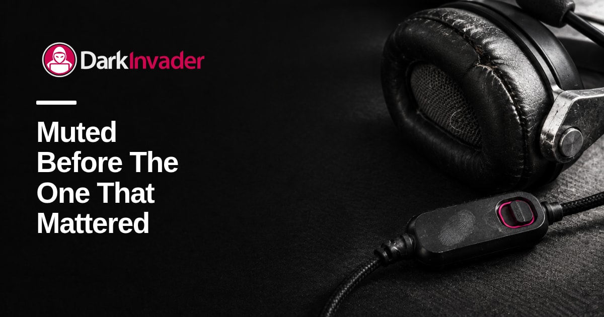 Close view of a worn office headset on a dark desk mat, its inline mute slider pushed across and boom folded away, with the words "Muted Before The One That Mattered" set on it
