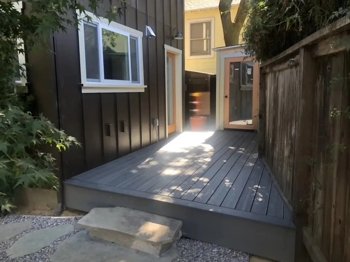 Side yard after an exterior renovation with a new deck