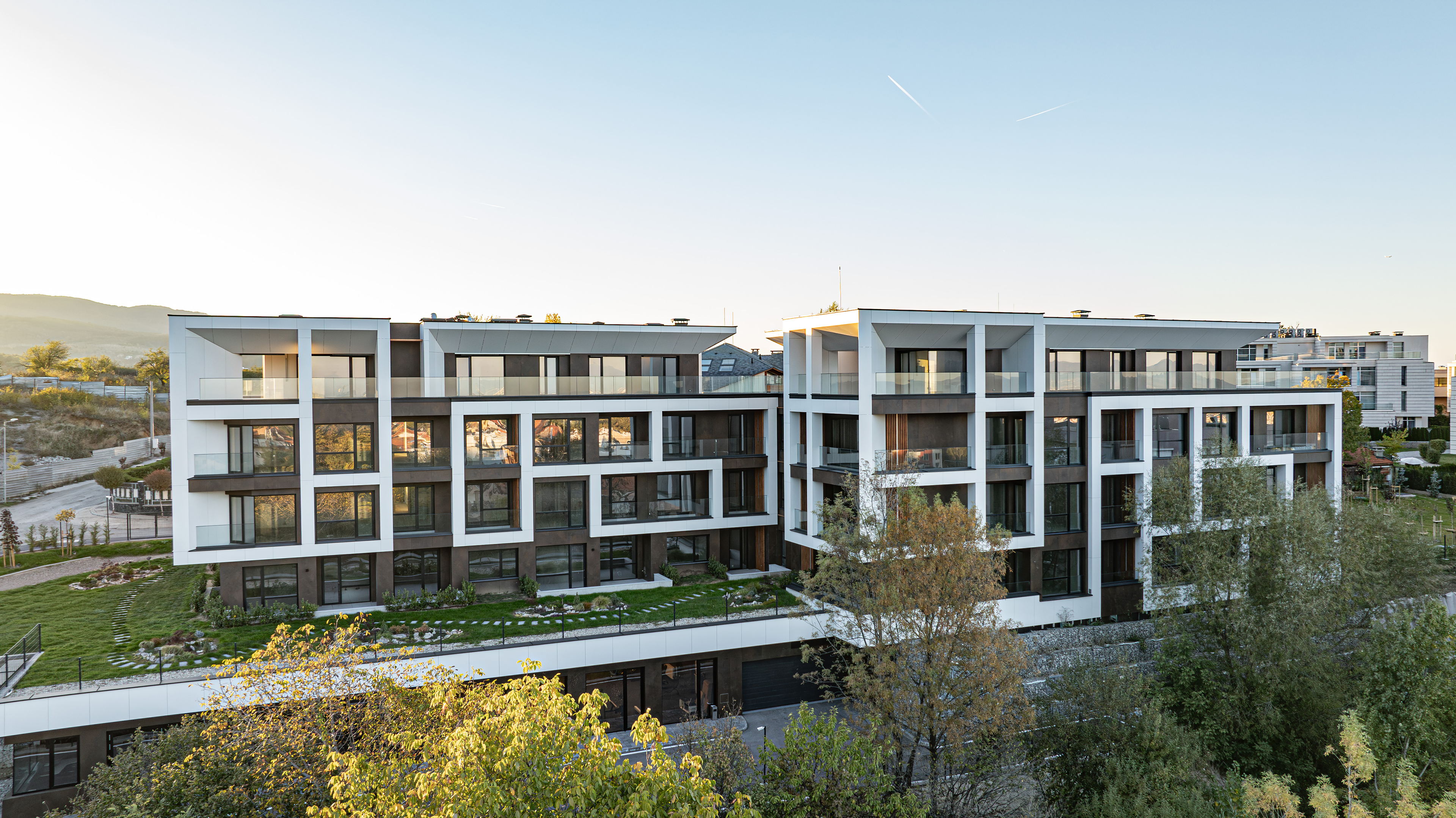 The Royal Residence — the two residential volumes seen across the landscaped slope