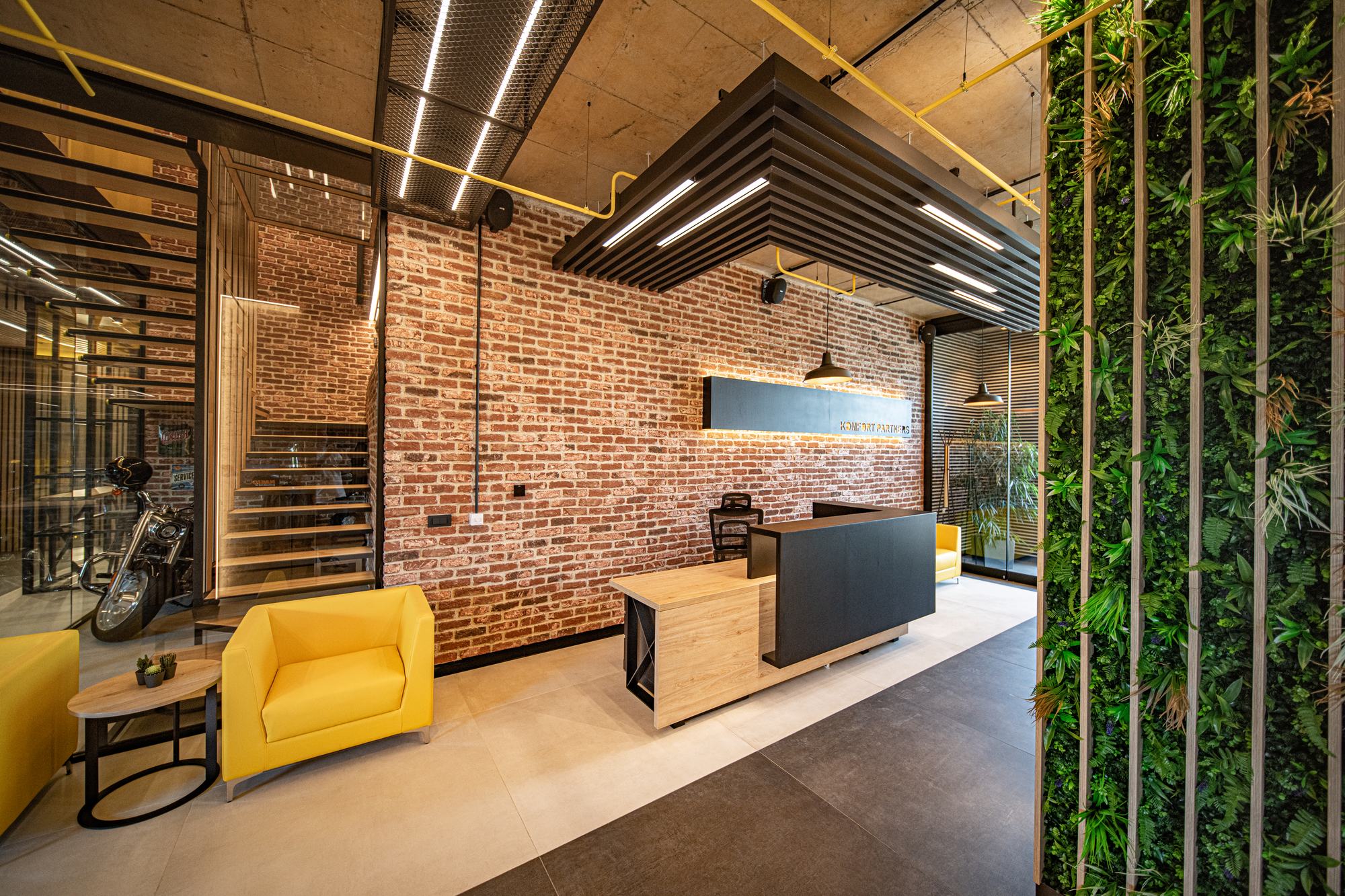 Comfort Partners Headquarters — reception desk against the exposed brick wall