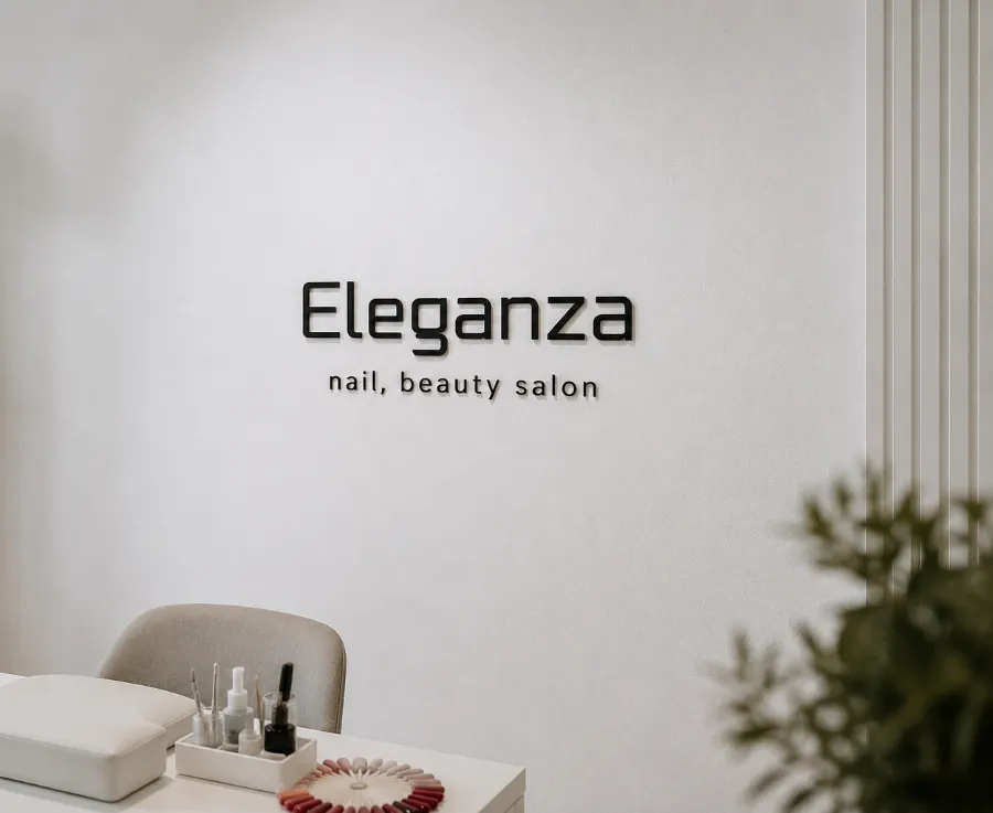 Interior of nail and beauty salon Eleganza with tools and nail polish display on a white table.