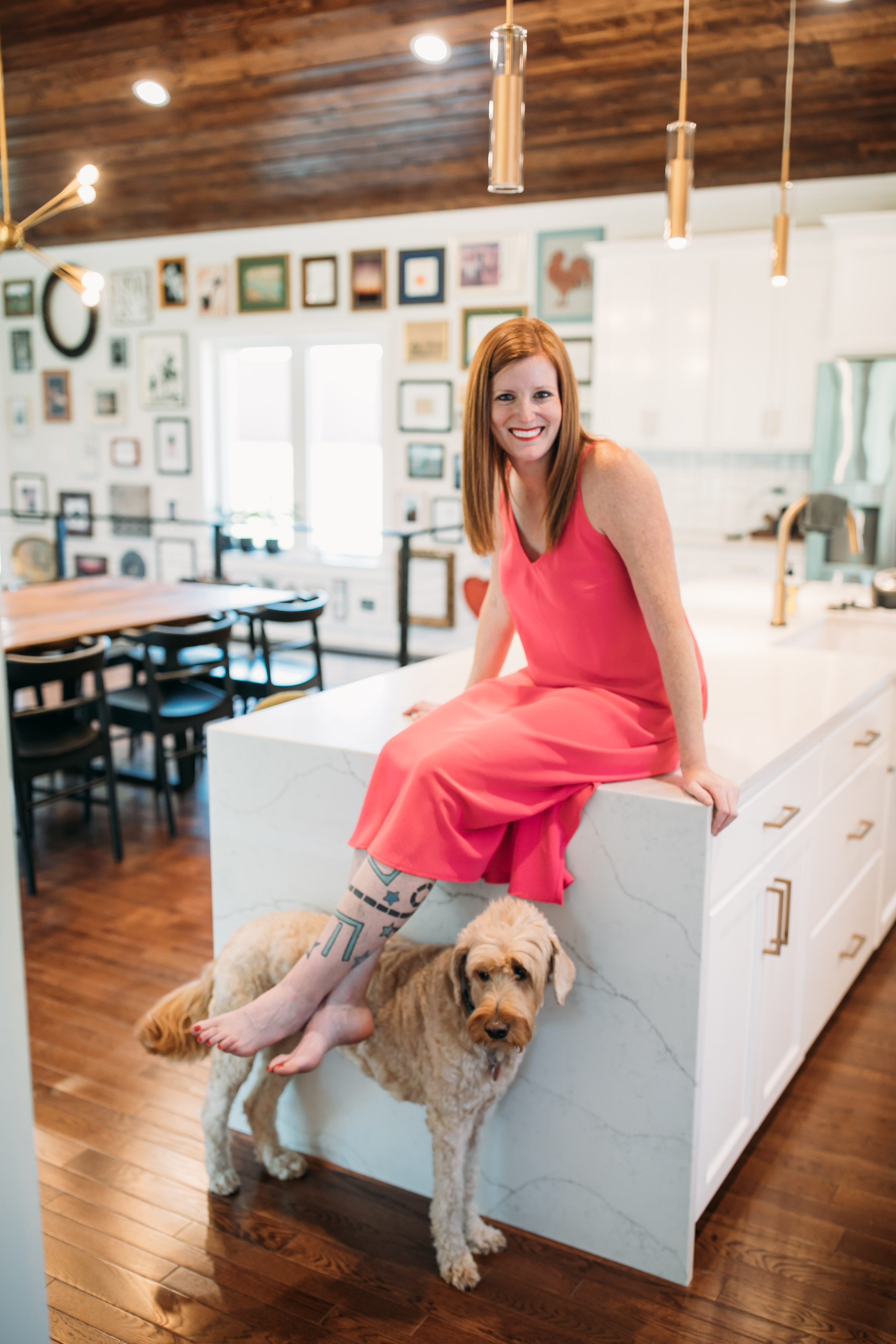 Krista Shelton smiling while holding two dogs.