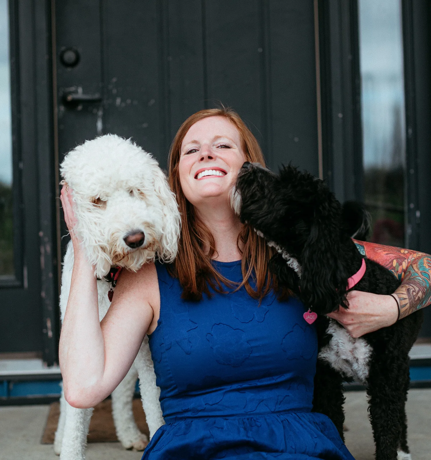 Krista Shelton smiling while holding two dogs.