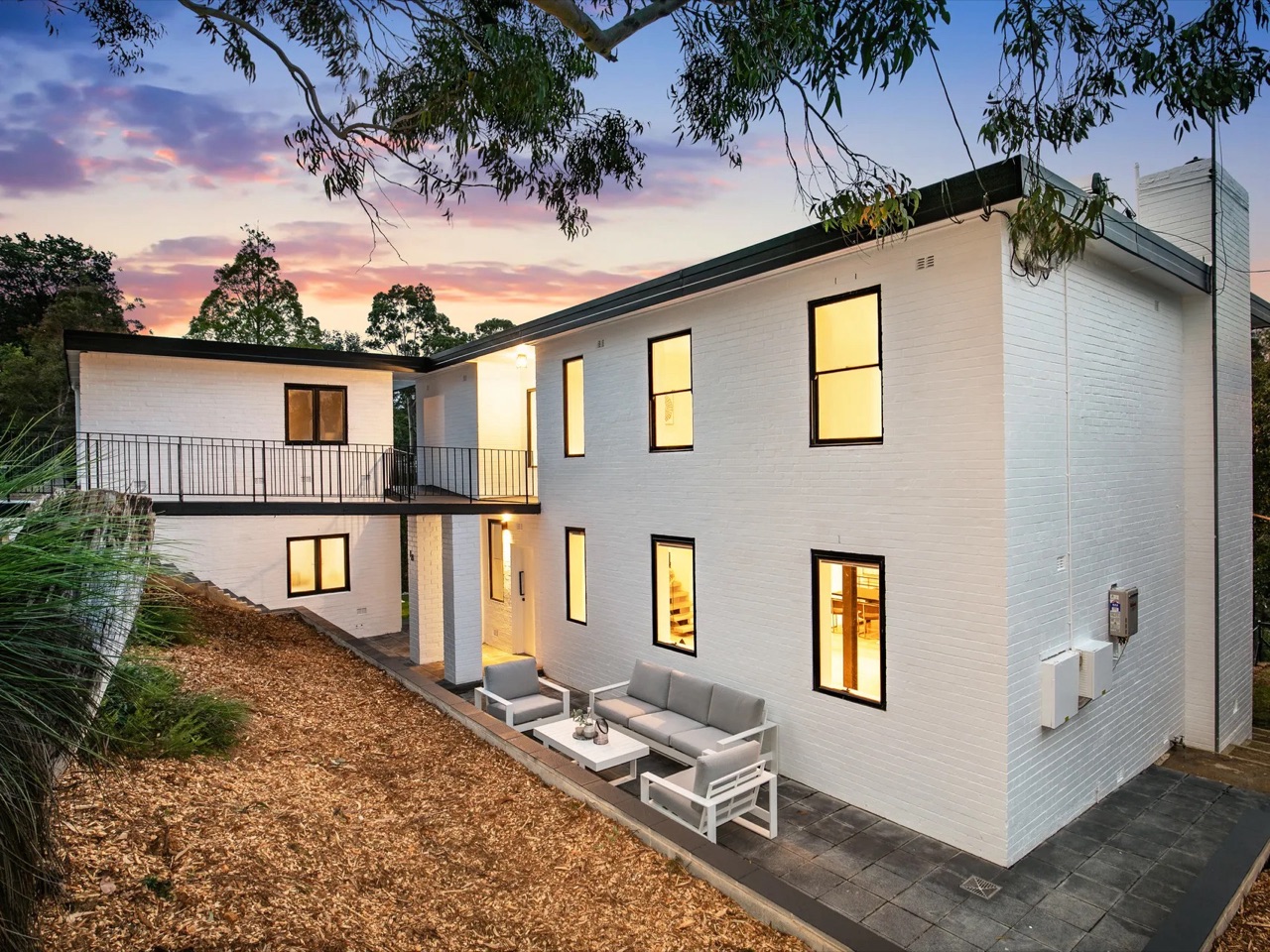 Completed FLIPRO presale renovation lit at dusk