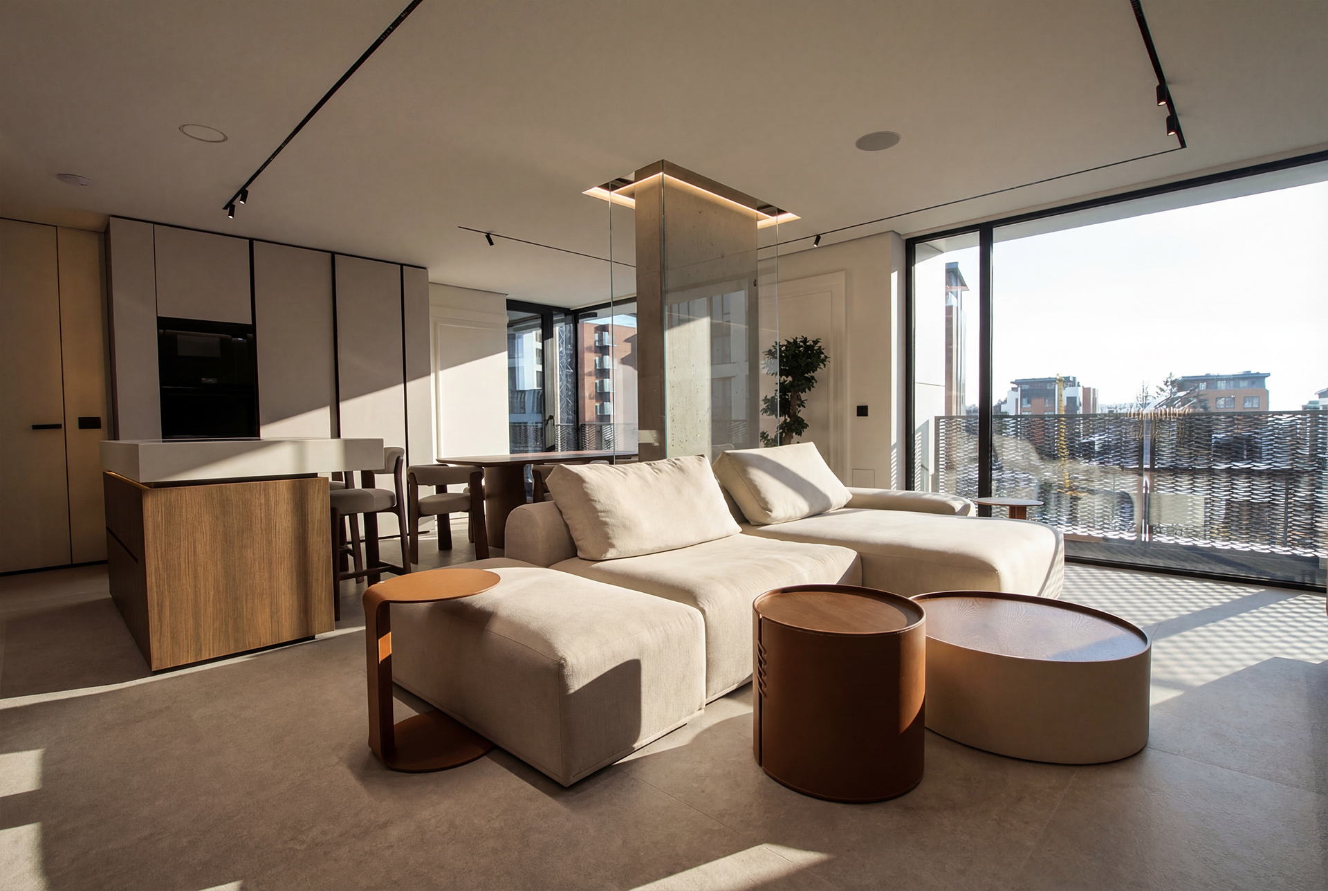 An apartment interior in exposed concrete, oak and stone, open to the city.