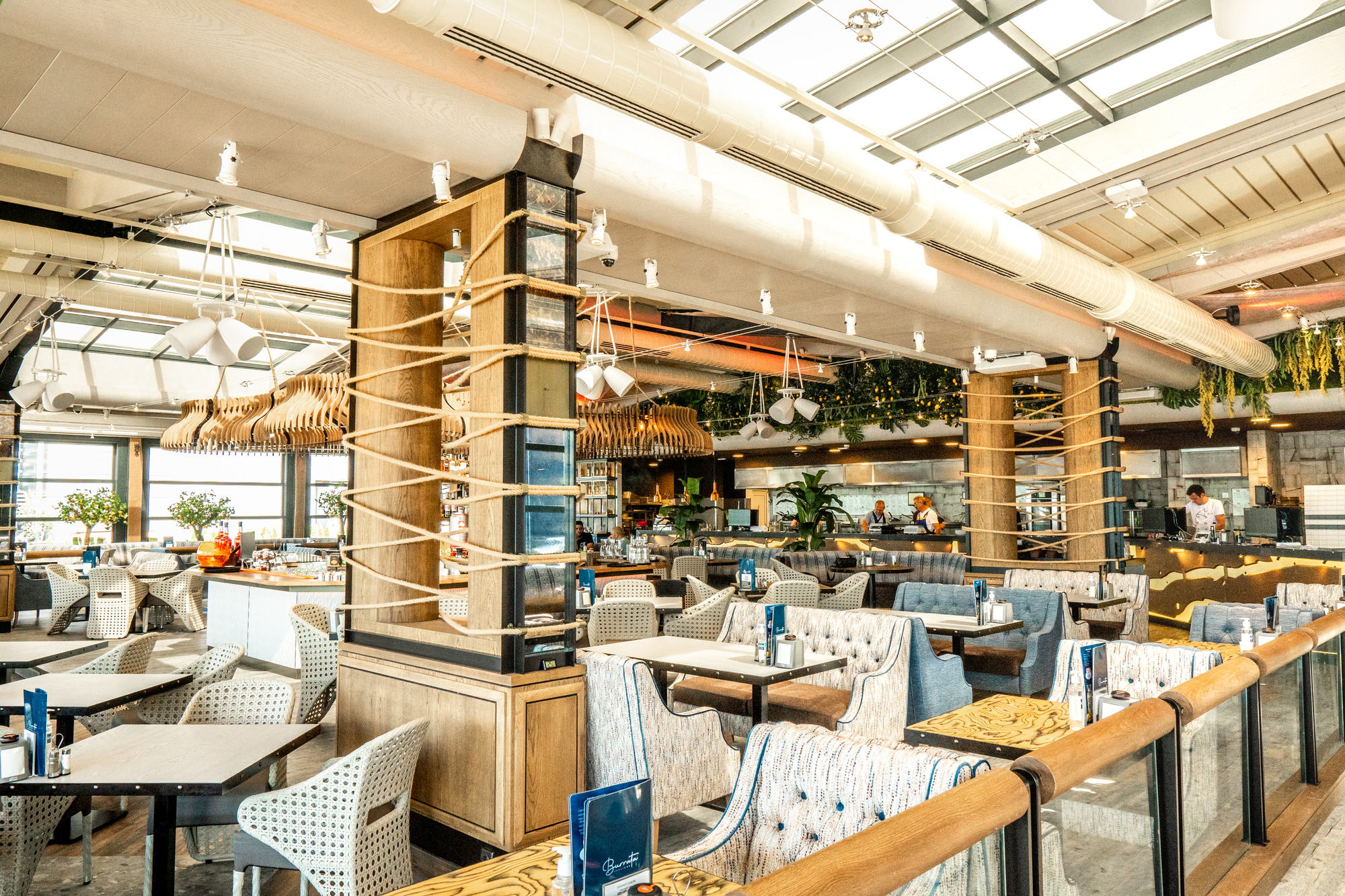 Restorant Burrata Harbour — tables beneath the ceiling fans