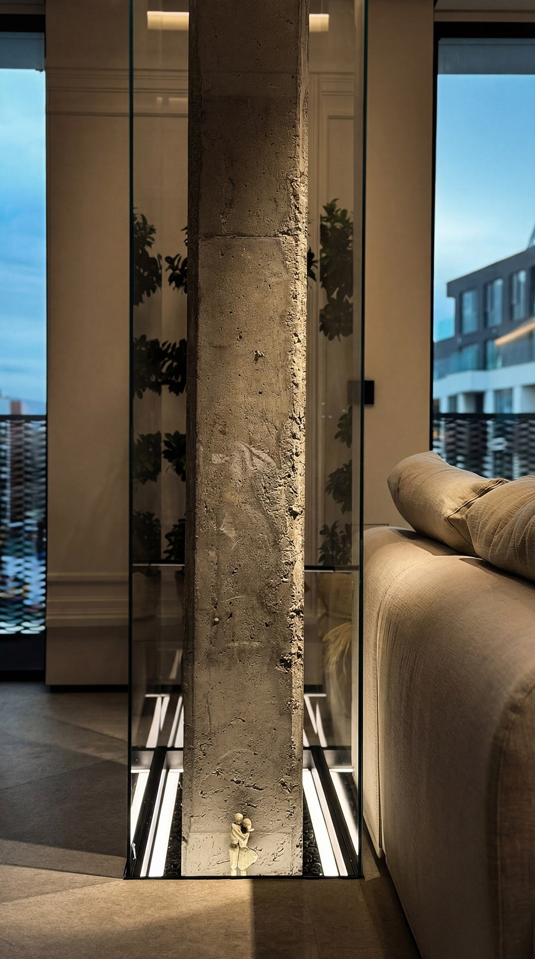 RUH A43 — exposed concrete column beside the sofa