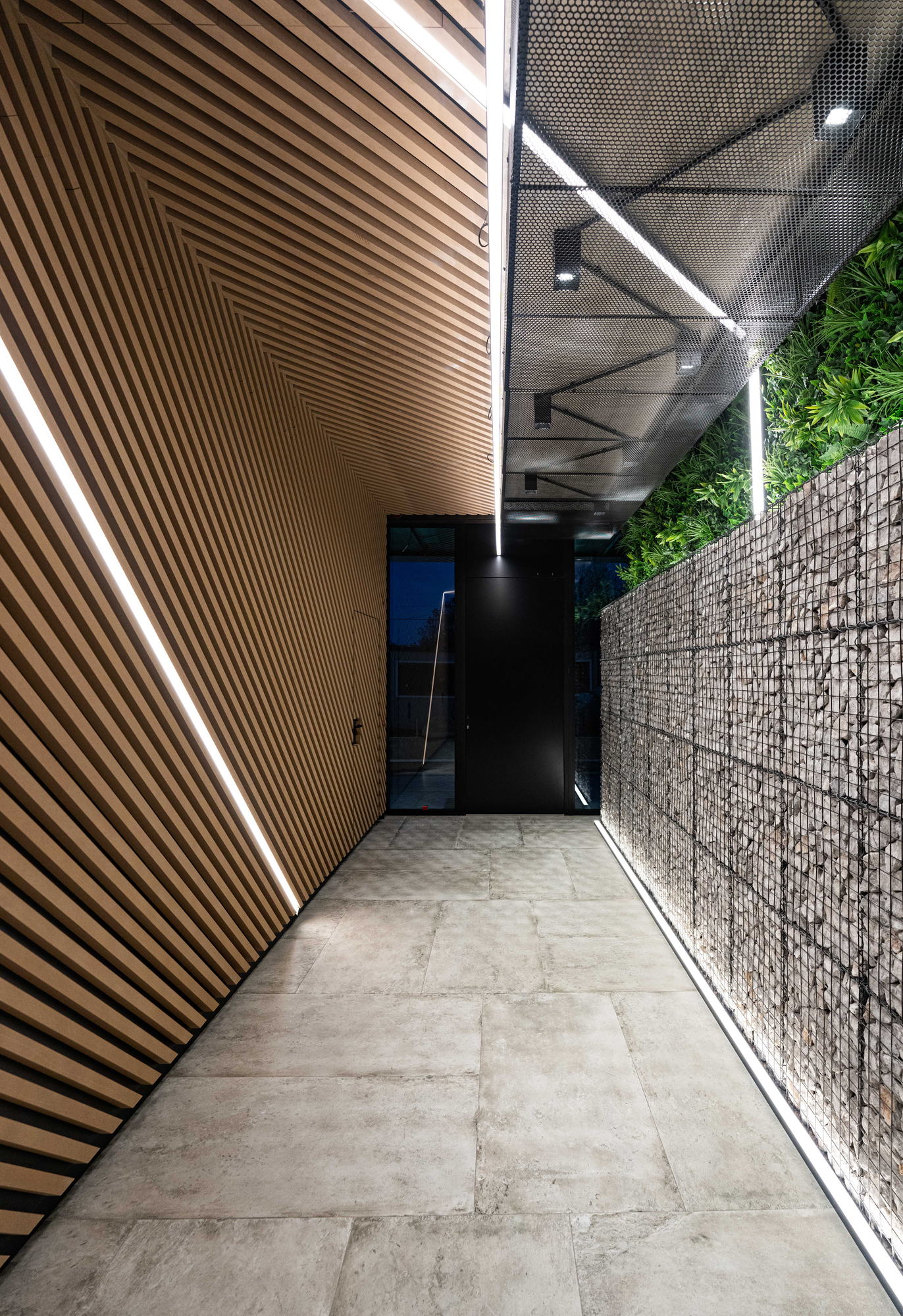 RUhouse II — lit passage between the green walls