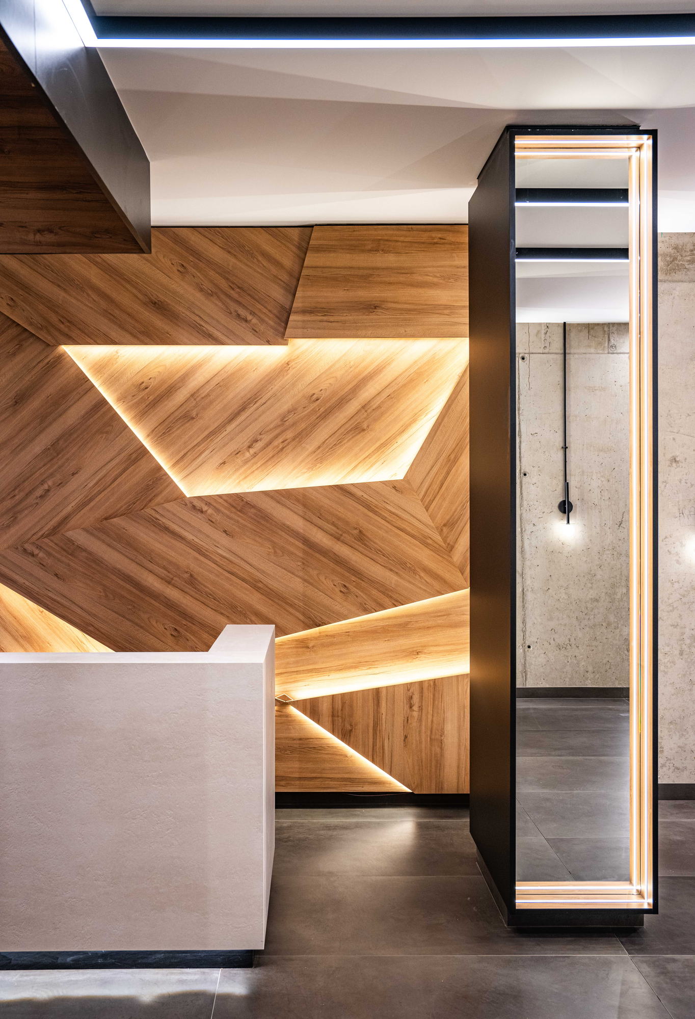 The Royal Residence — reception desk and lit timber panelling