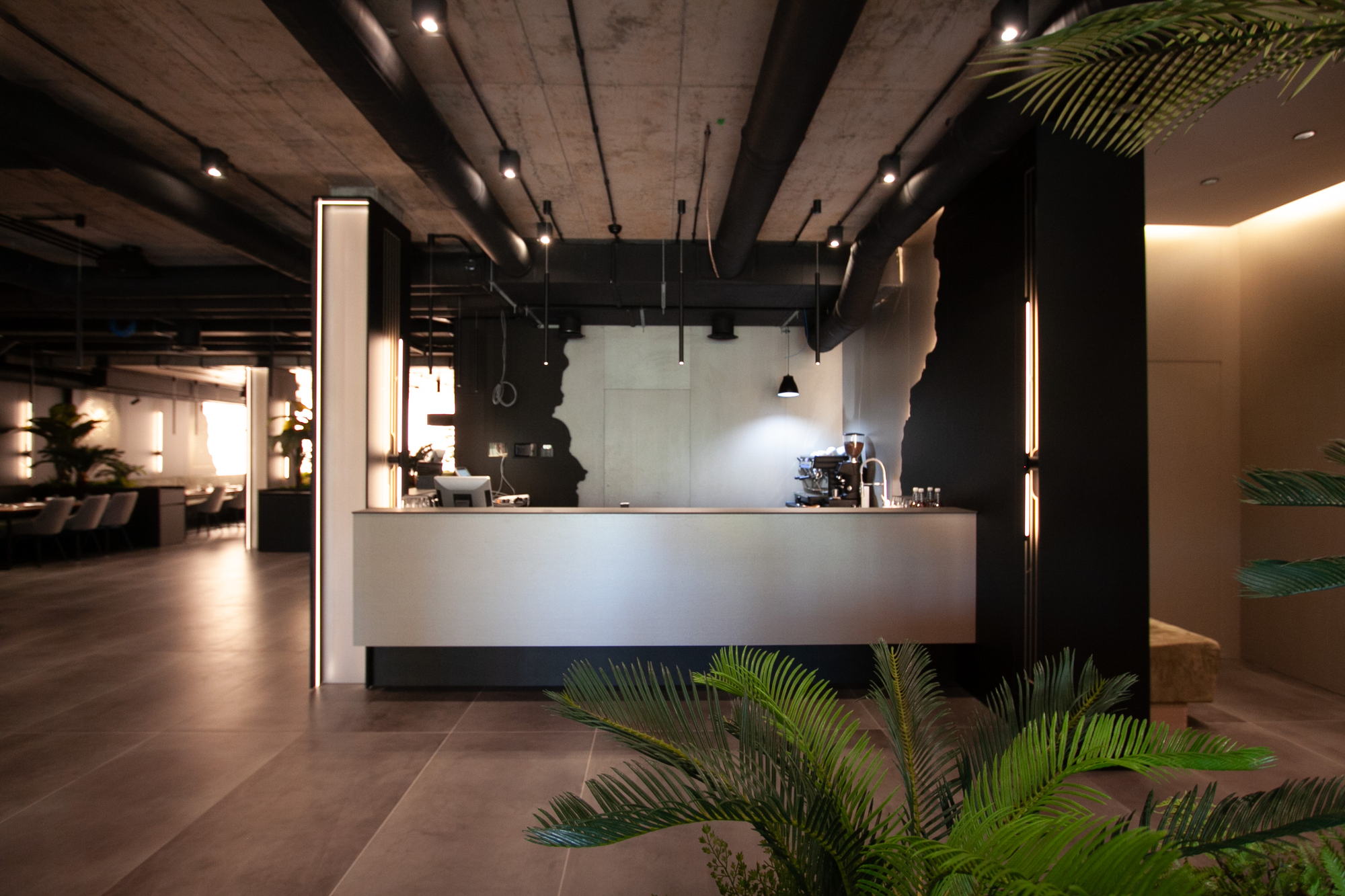 The Royal Residence — reception counter and planted foreground