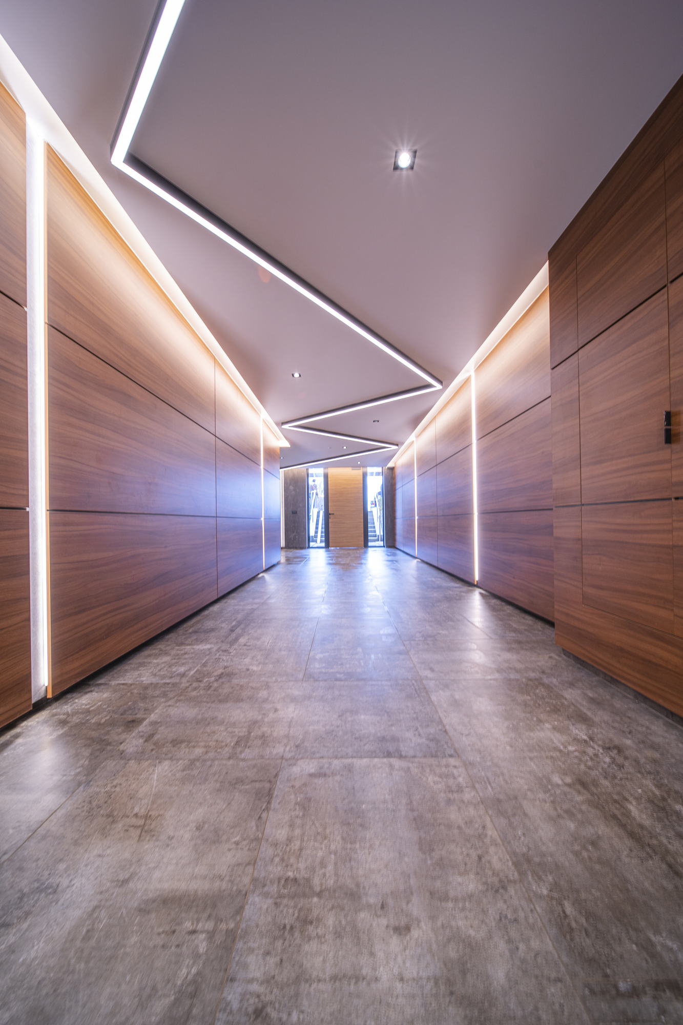 RUhouse — foyer corridor lined in timber with a folded ceiling light line