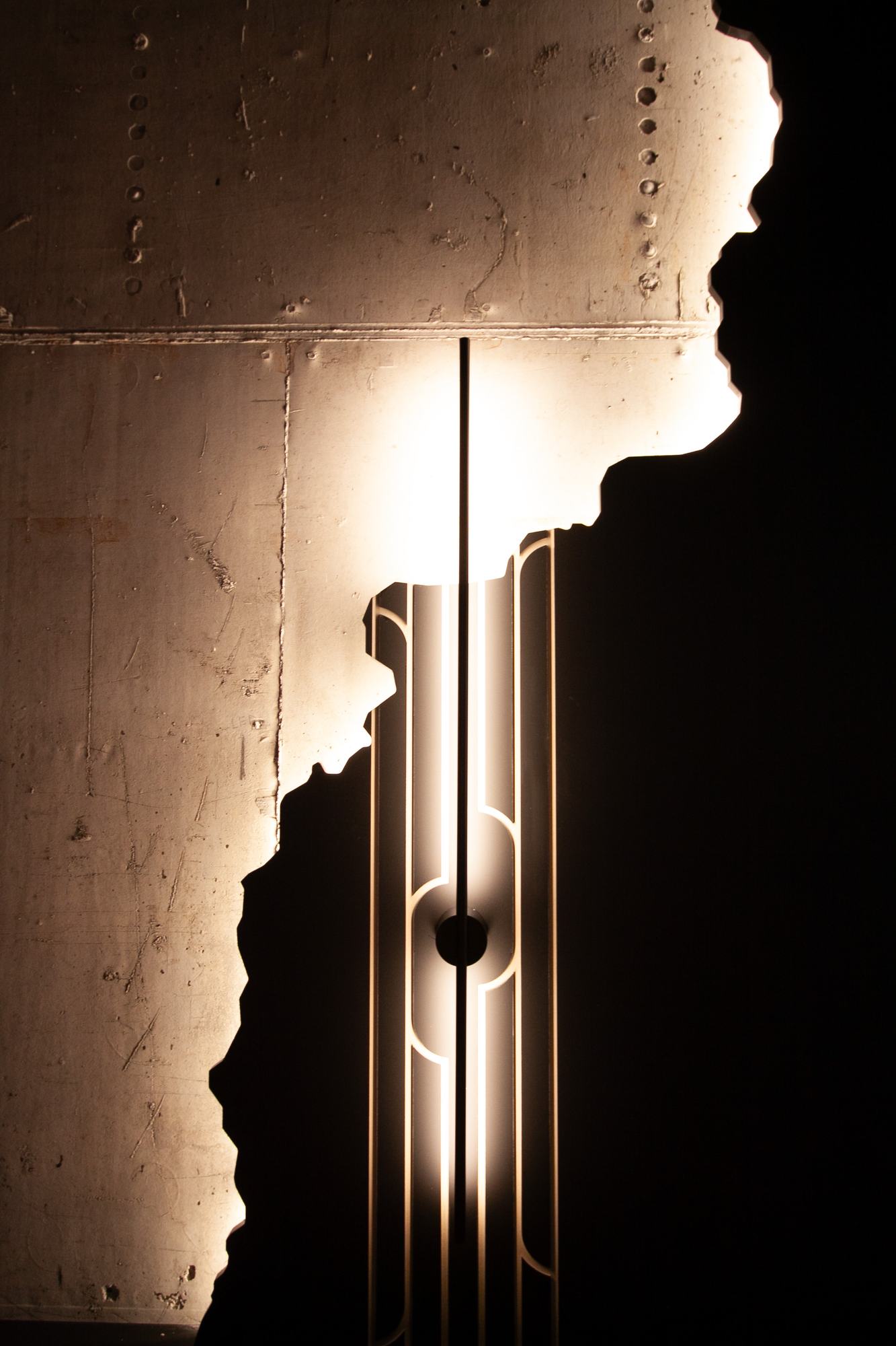 The Royal Residence — a linear light against the torn edge of the concrete wall
