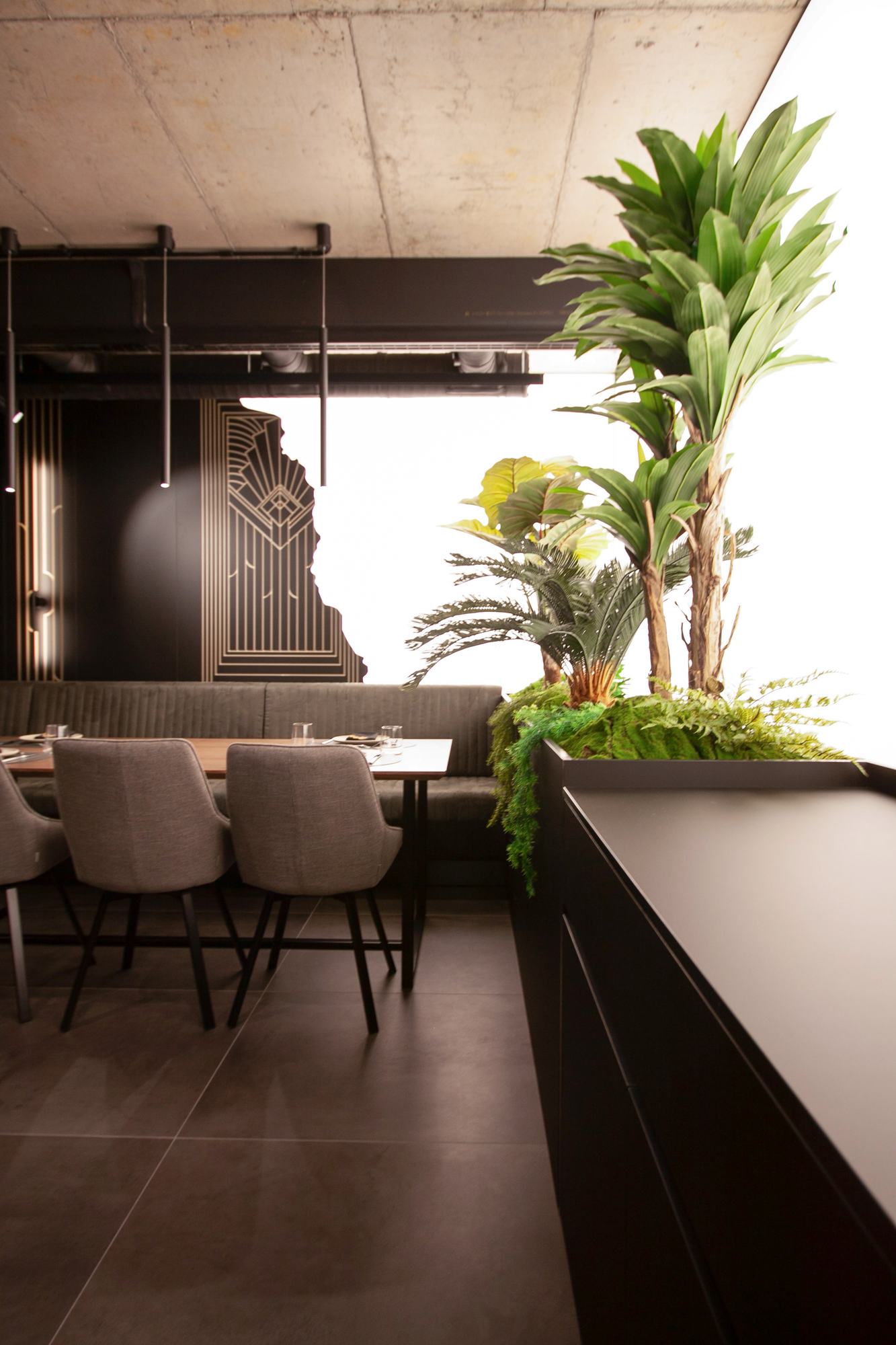 The Royal Residence — restaurant seating behind the planted screen