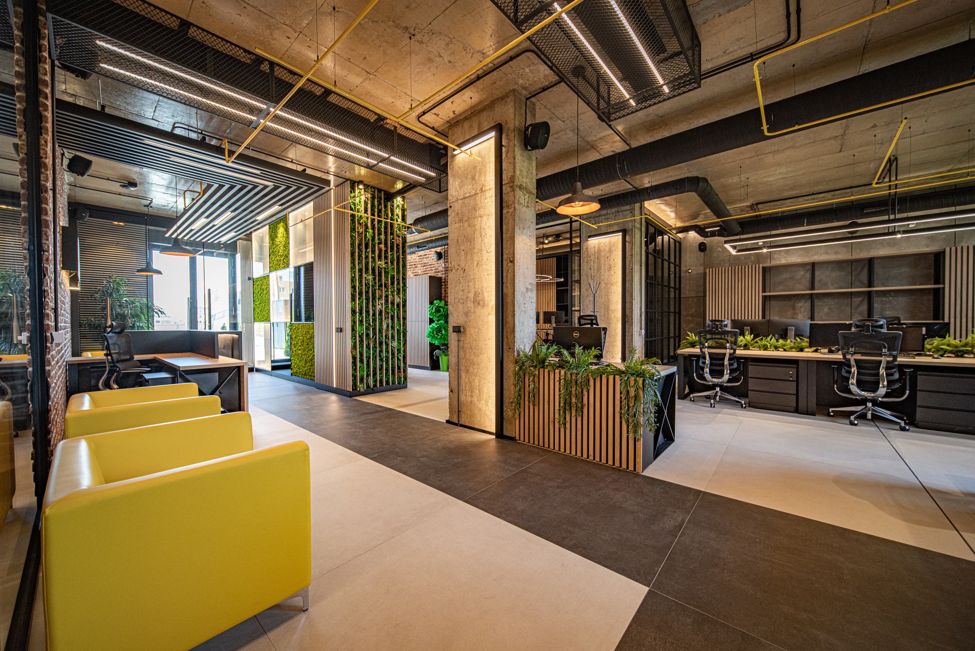 Comfort Partners Headquarters — open plan with yellow booth seating and planting