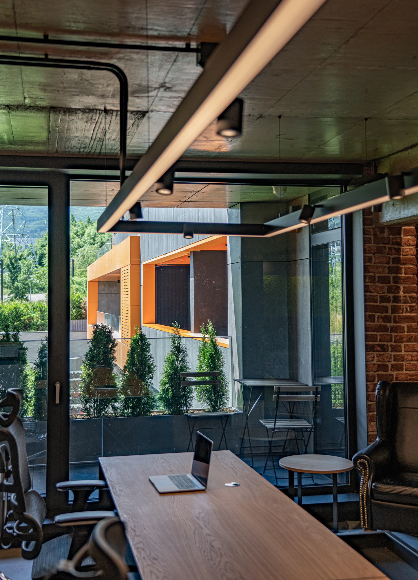 Comfort Partners Headquarters — a desk beside the glazing onto the terrace