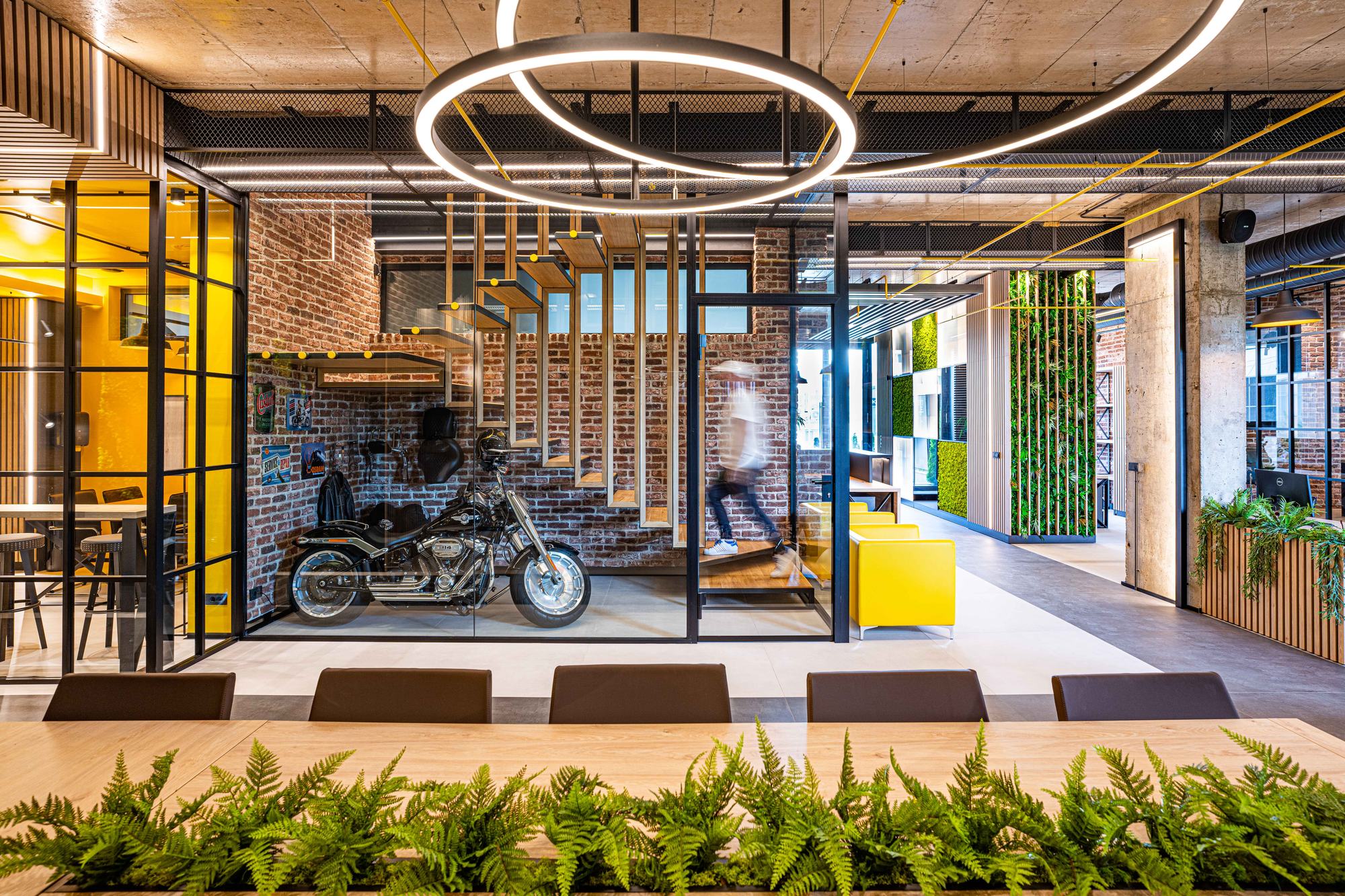 Comfort Partners Headquarters — the motorcycle display and ring pendants across the open floor