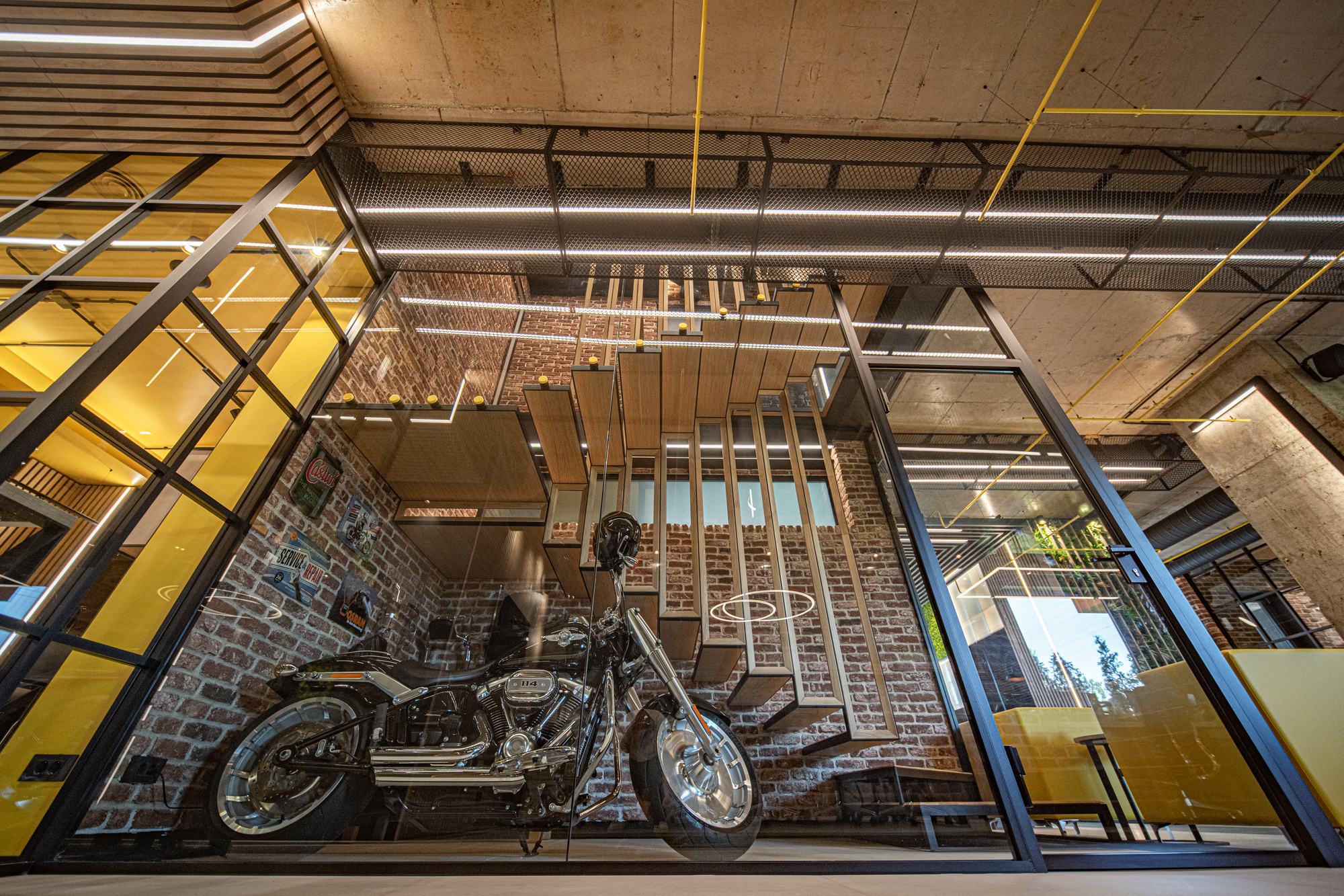 Comfort Partners Headquarters — looking down through the glass floor to the motorcycle and brick wall below