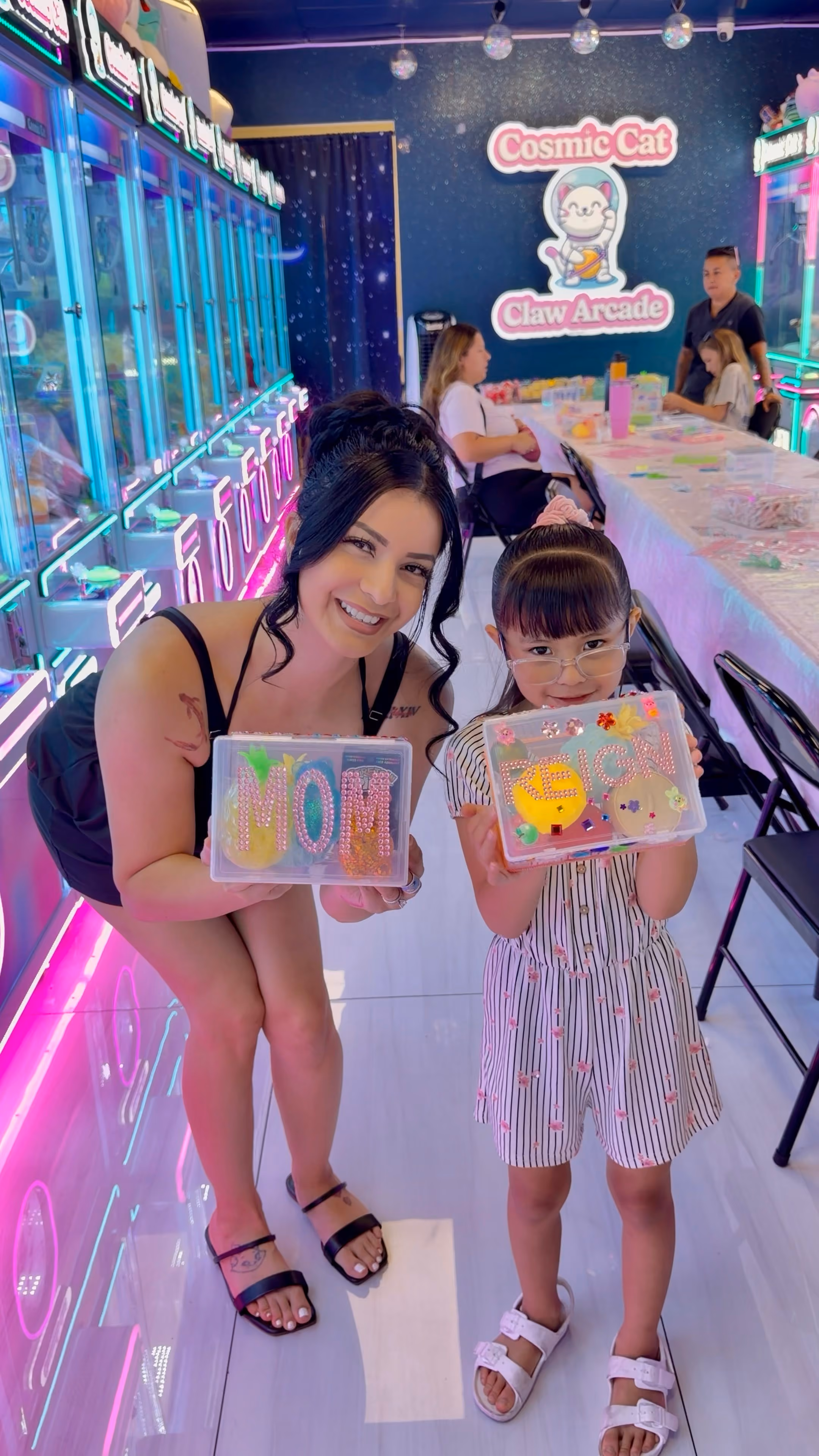 A parent and child holding the keepsake boxes they decorated