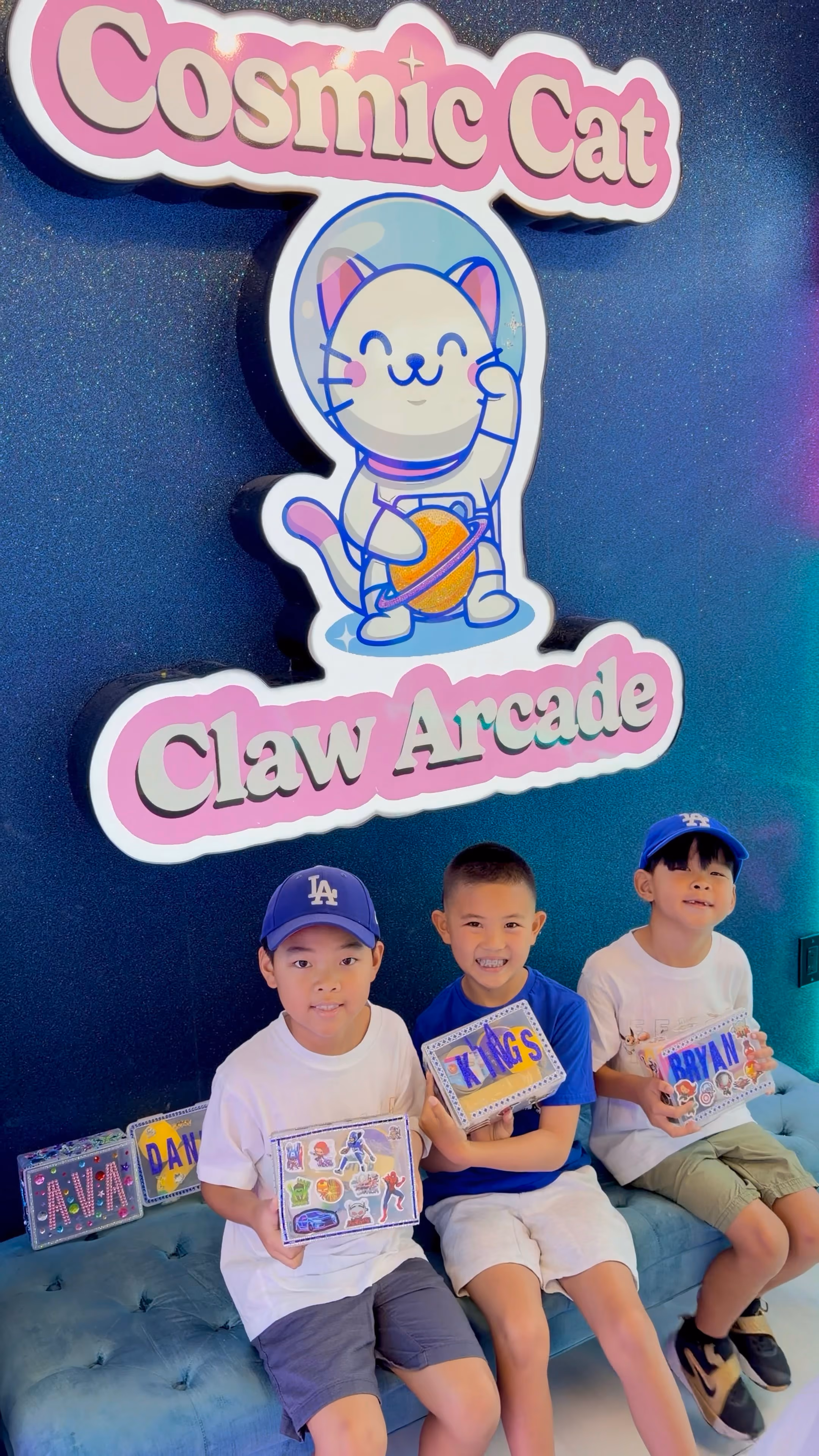Three children on the lounge seat with their finished boxes