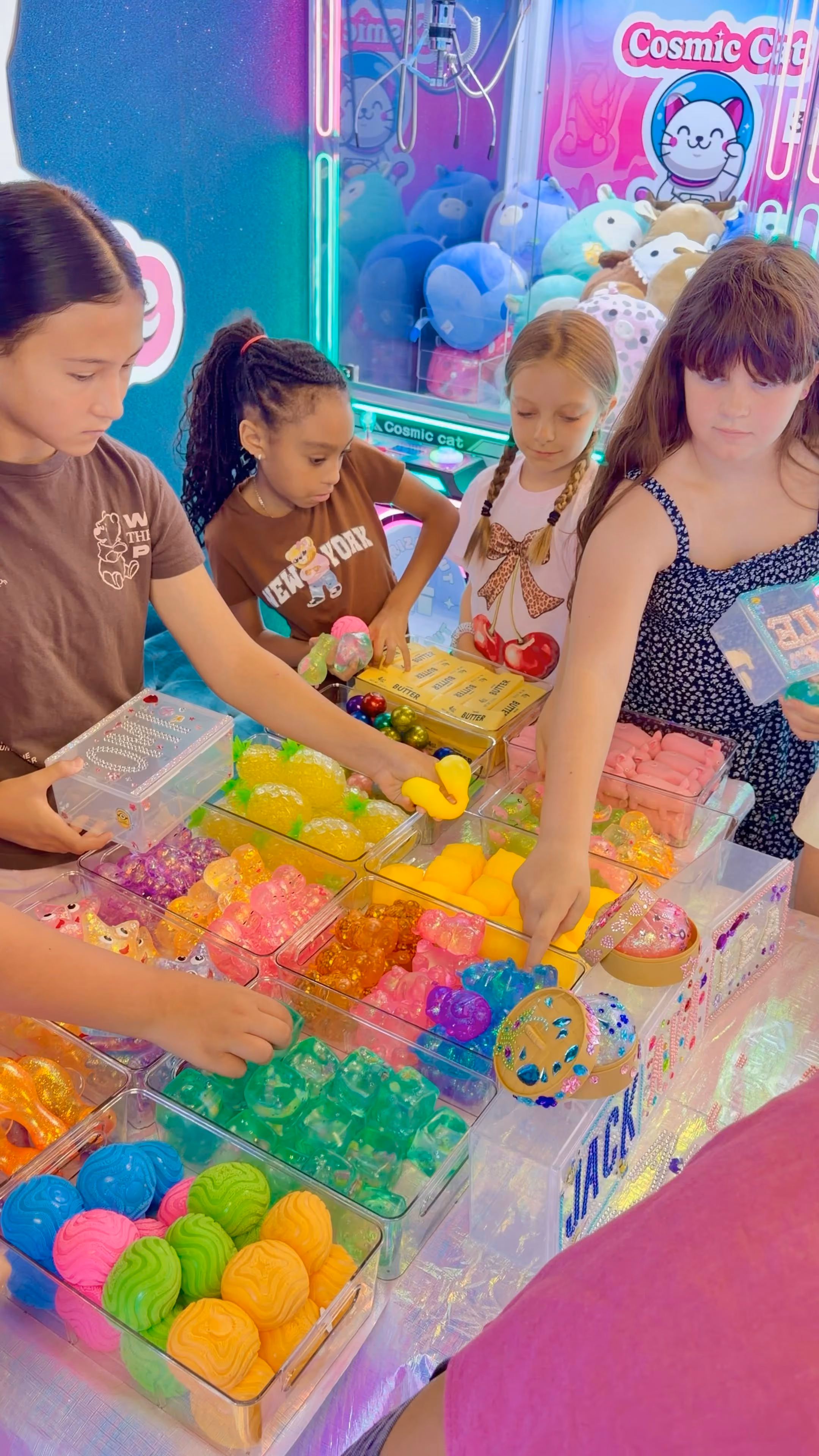 Children choosing squishies from the trays at the Squishy Bar