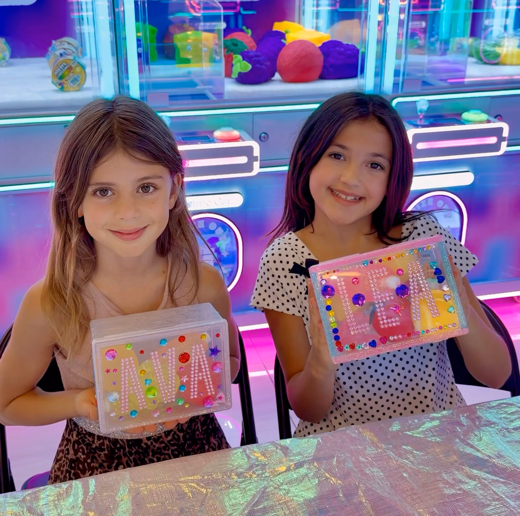 Two girls holding the keepsake boxes they decorated