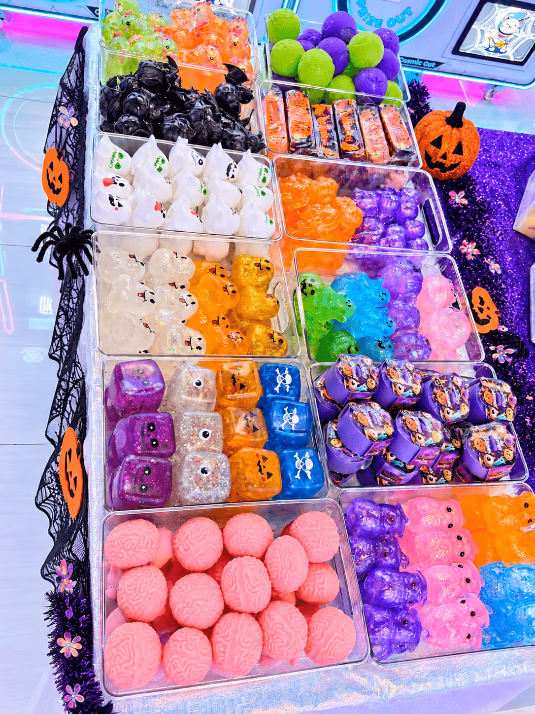 Trays of Halloween squishies at the Squishy Bar: pumpkins, ghosts, bats, eyeballs and pink brains