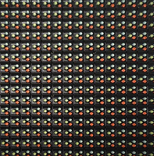 Close-up of a grid of small LED lights with red, green, and yellow diodes on a black panel.