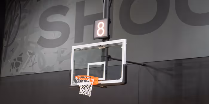 Basketball hoop with white backboard and orange rim under a scoreboard showing the number 8.