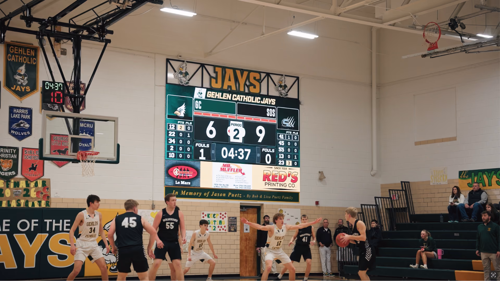 High school basketball game with scoreboard showing Gehlen Catholic 6, opponent 9 in period 2.