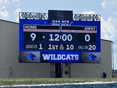 Football scoreboard showing Home 9, Away 0, 12:00 minutes, Quarter 1, 1st & 10, ball on 20.